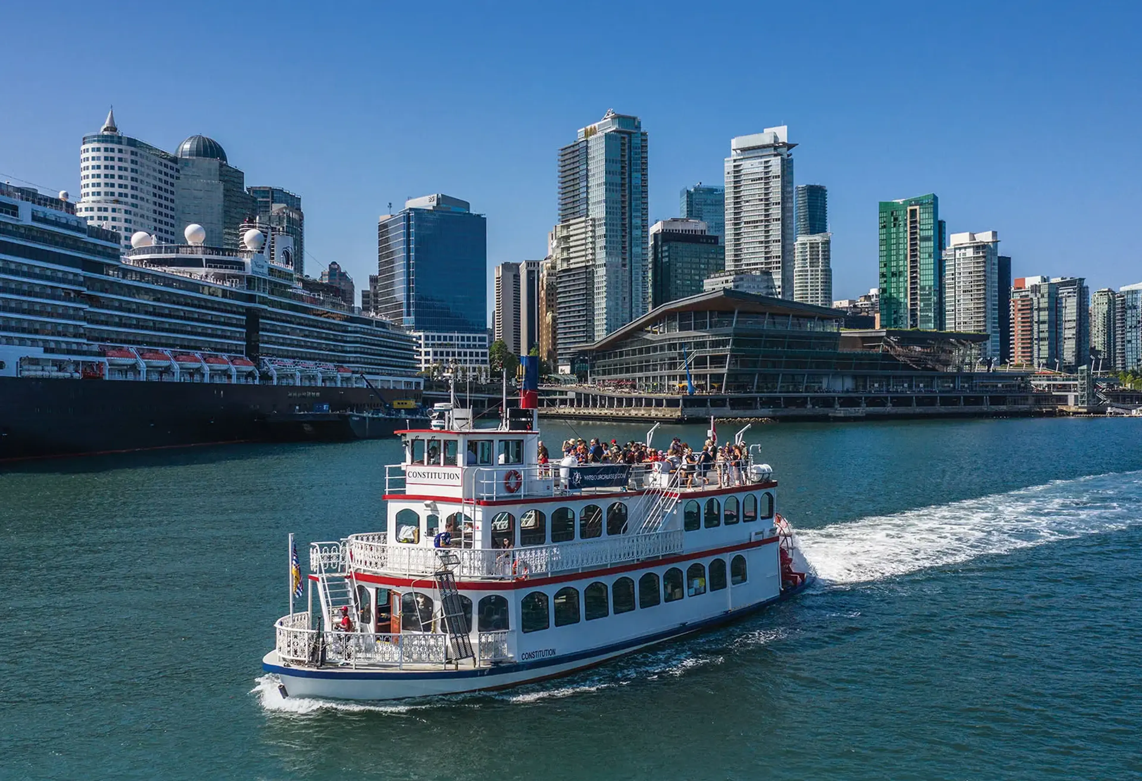 A Harbour Cruise boat passing the Convention Centre in Vancouver.