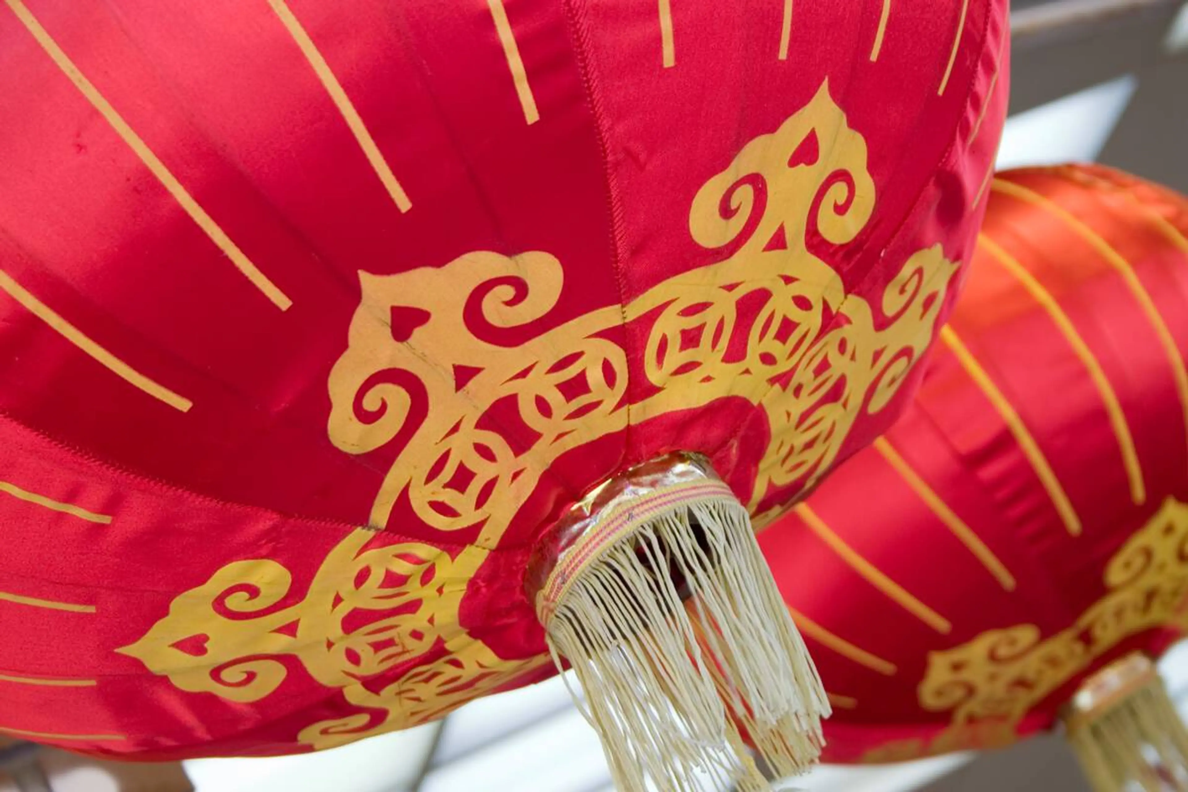 Close-up of red and gold silk Chinese lanterns in Chinatown