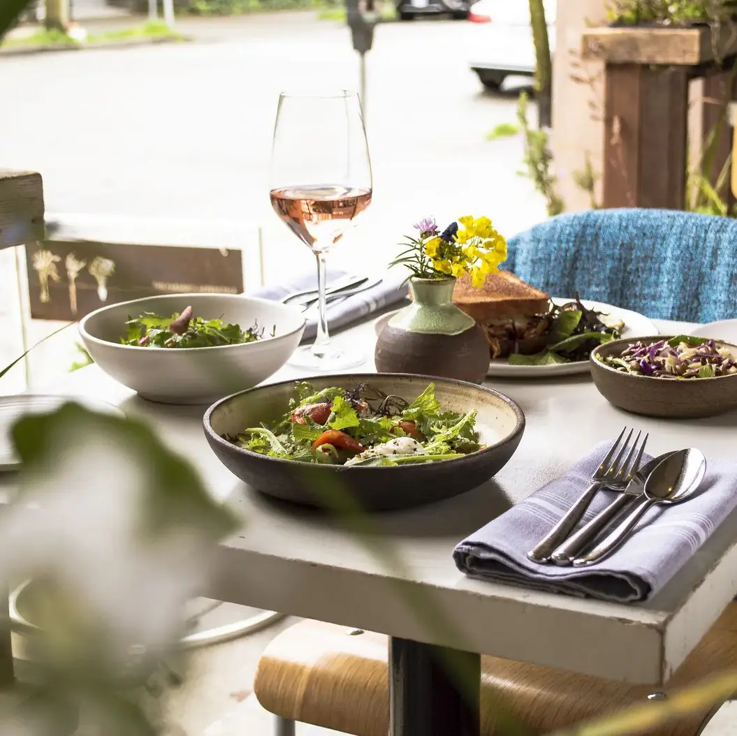 A table of food on the patio at Farmer's Apprentice in Vancouver