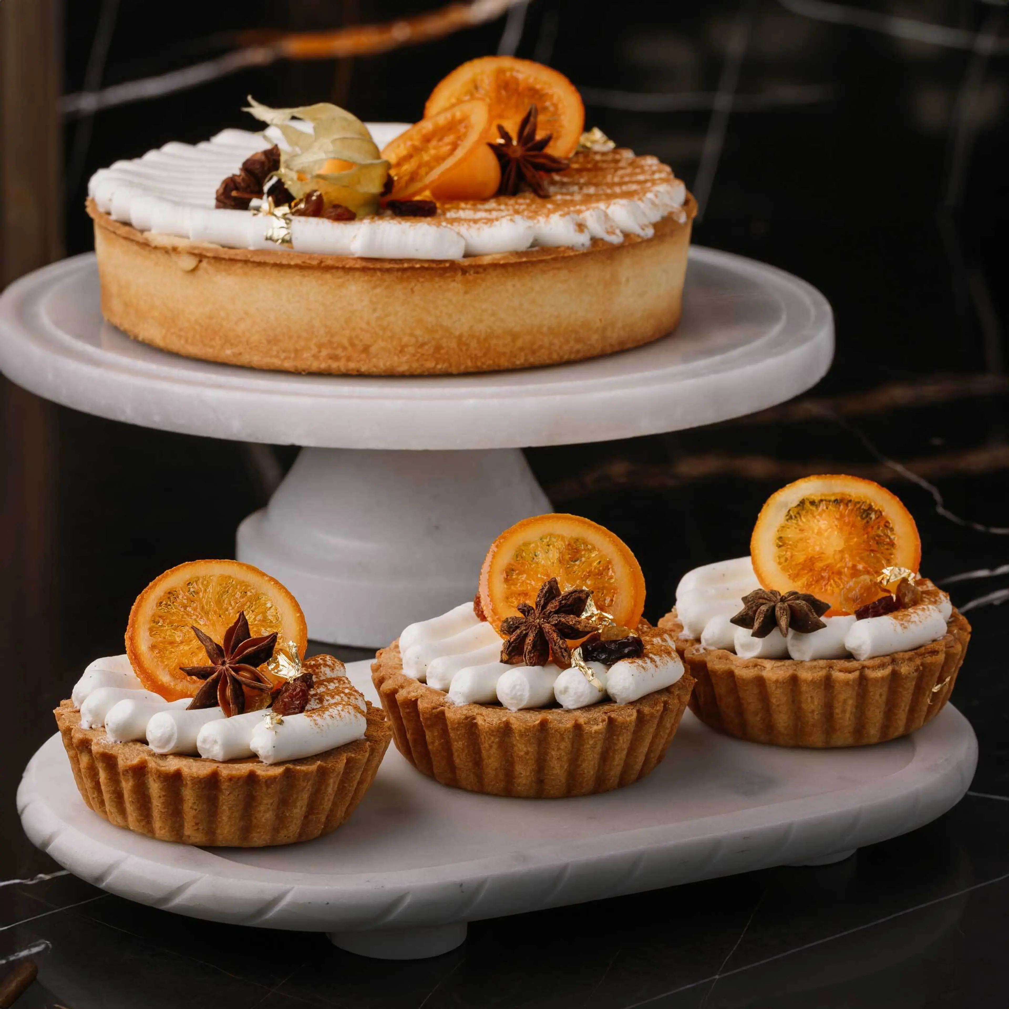Pumpkin tarts from Thierry arranged on a tiered cake stand.