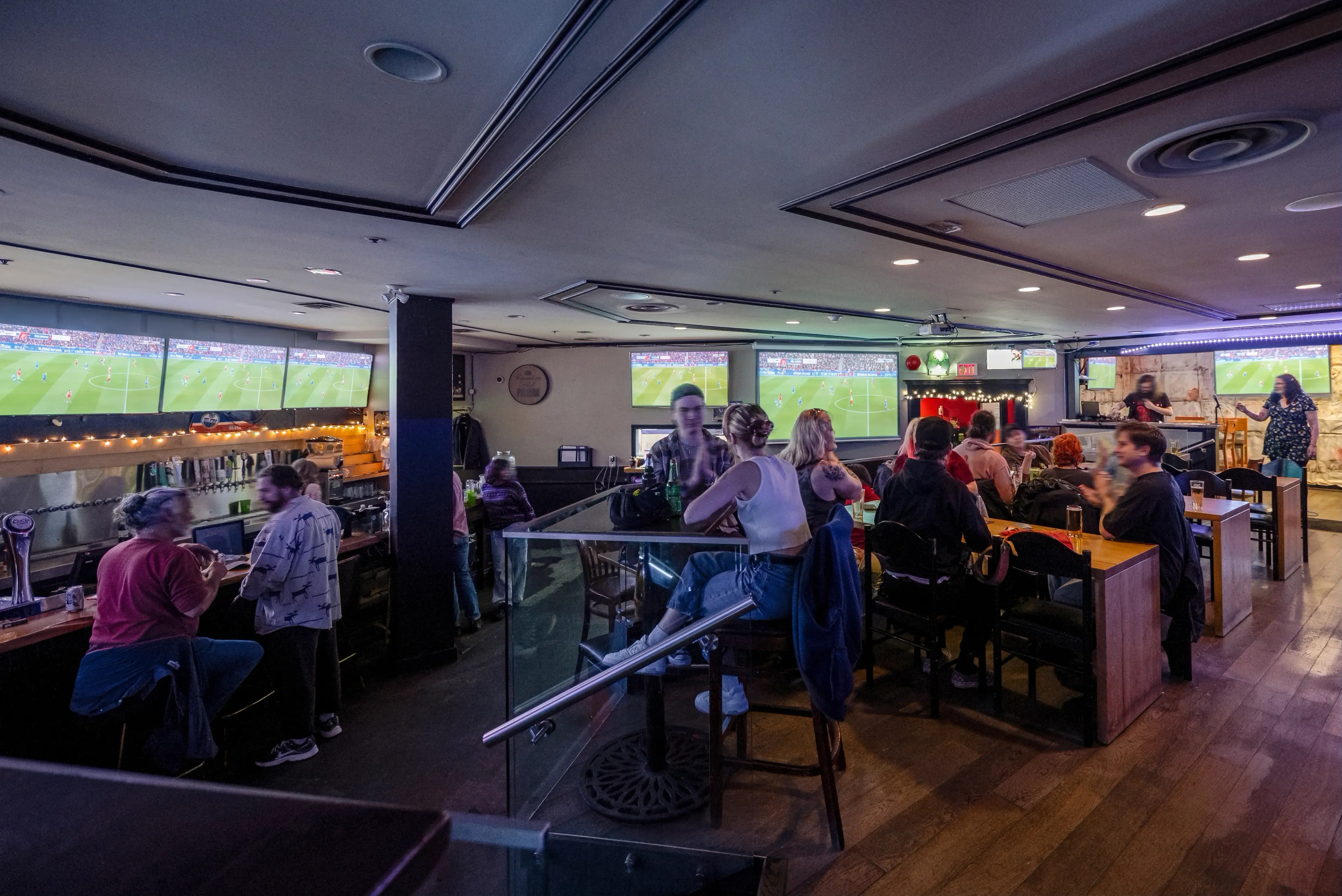 Interior image of the Junior's Pub in Vancouver with soccer on the screens in the background..
