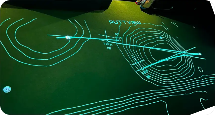 A projected model of topography and golf putt trajectory on an indoor golf green at Ultimate Golf Lounge in Vancouver.