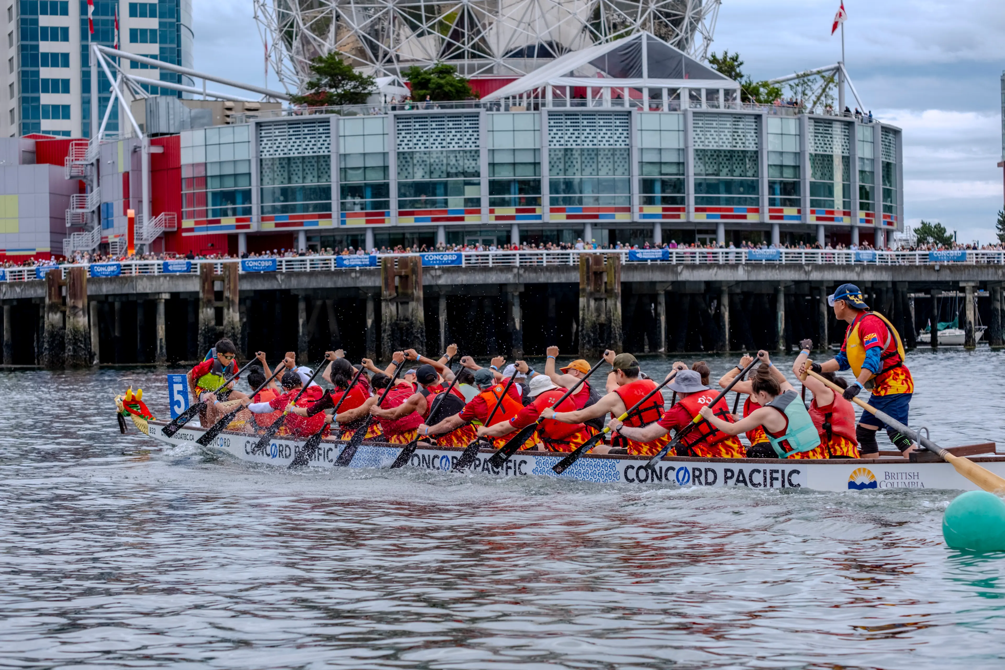 Racers compete in the Concord Pacific Dragon Boat Festival; Science World in the background