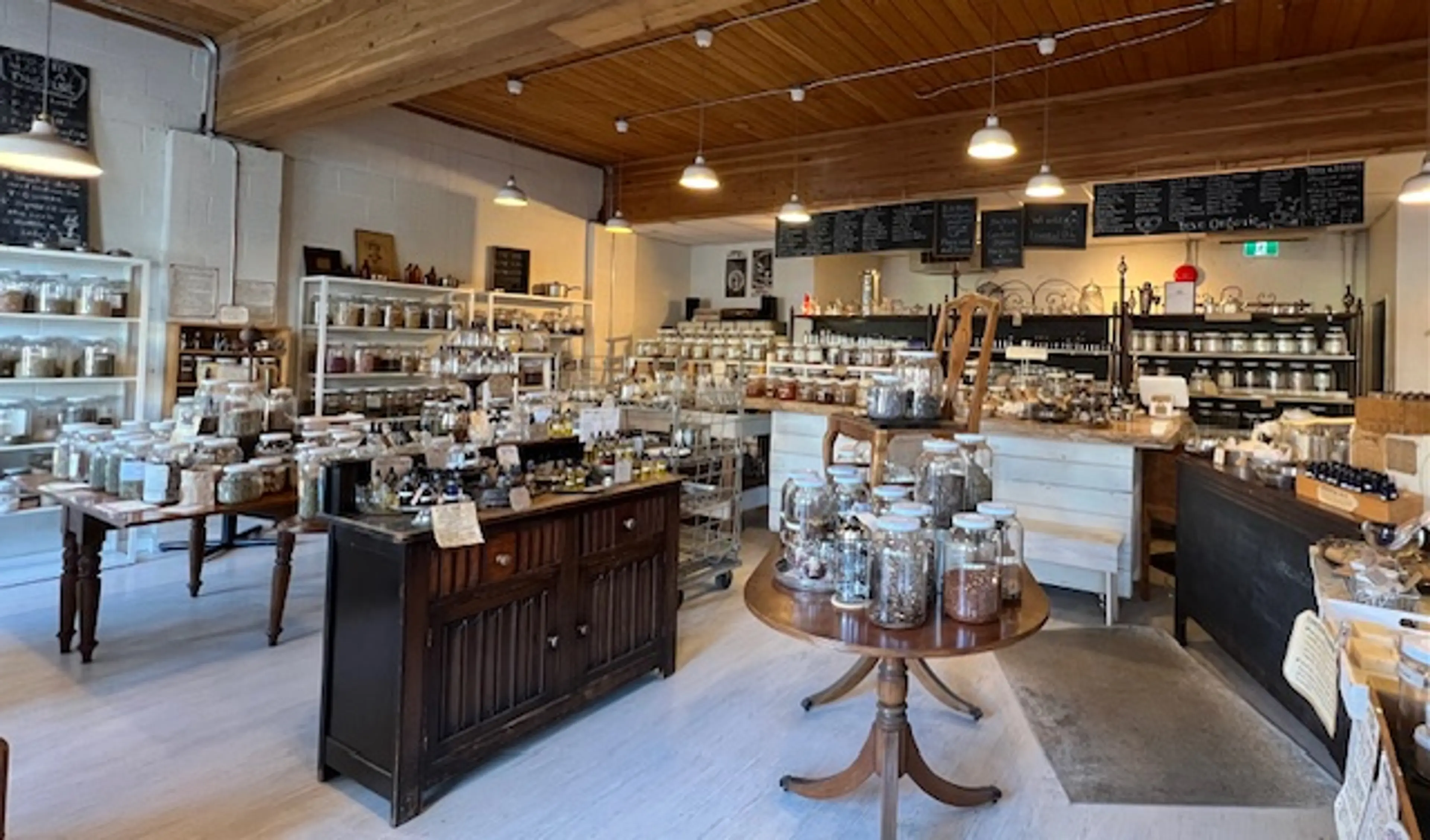 The interior of Balance Botanicals on Main Street. There are jars of herbs, teas, and spices lined up on shelves and counters. 