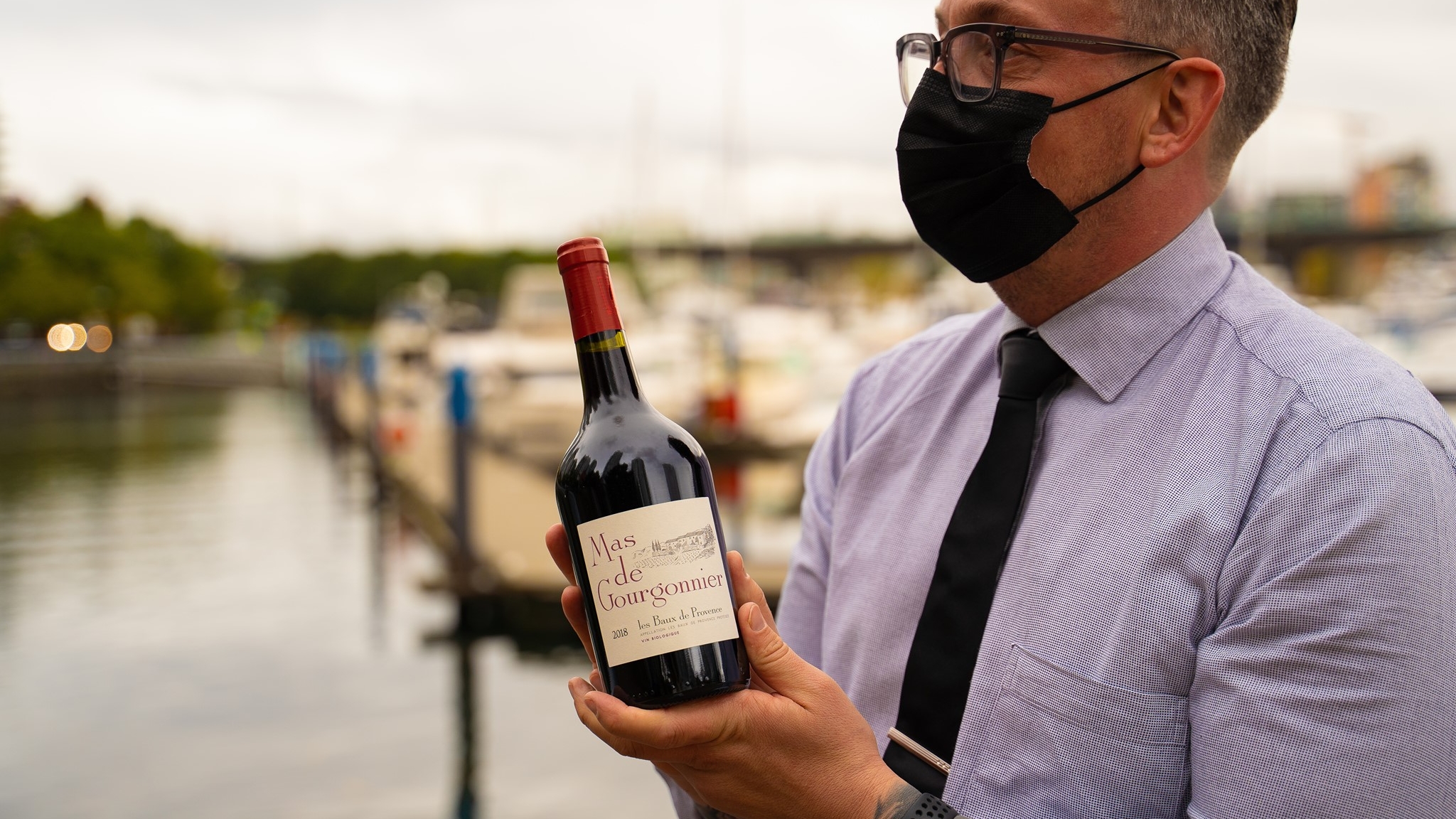 Waiter serving wine at Province Marinaside restaurant in Vancouver