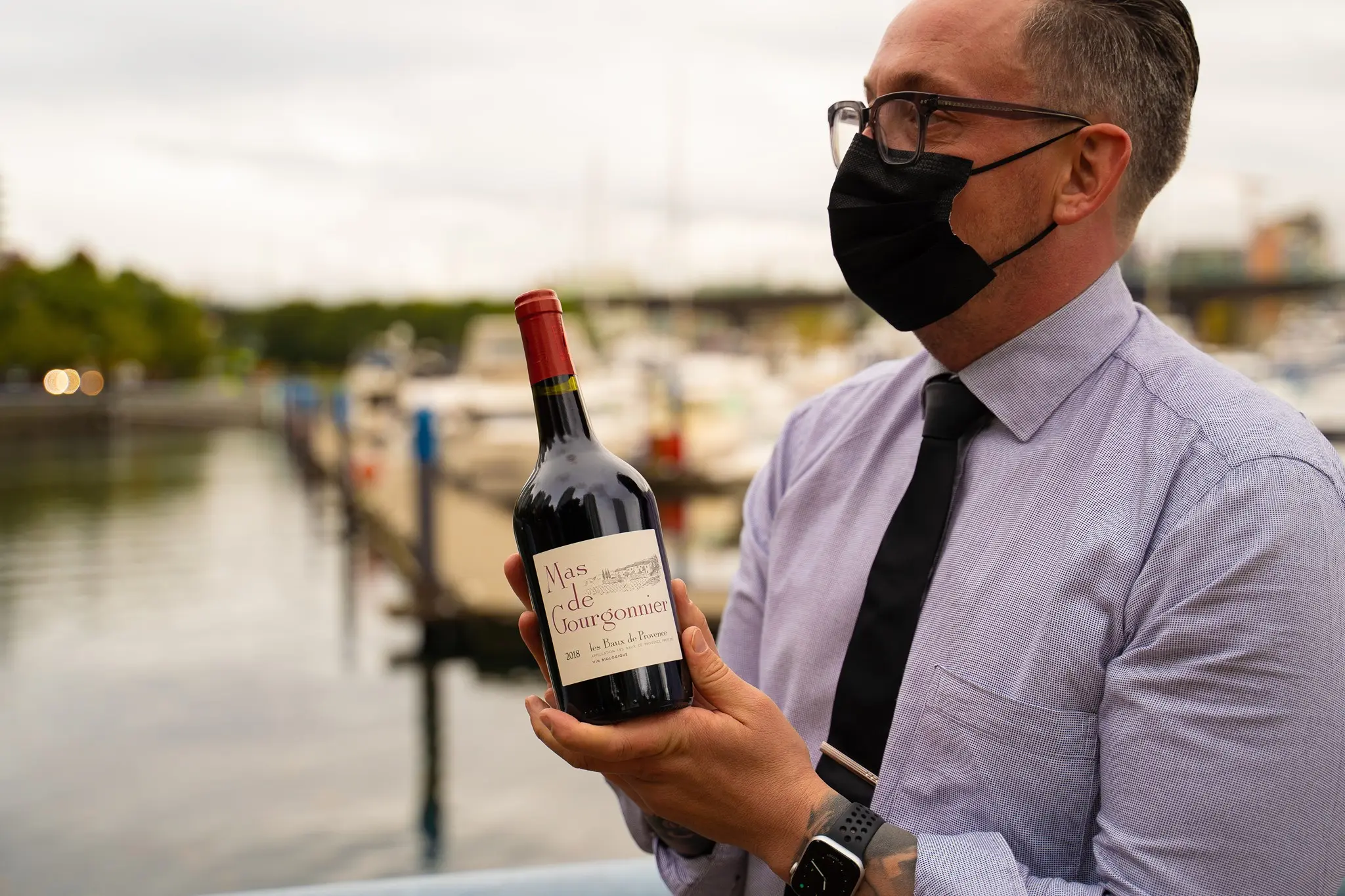 Waiter serving wine at Province Marinaside restaurant in Vancouver