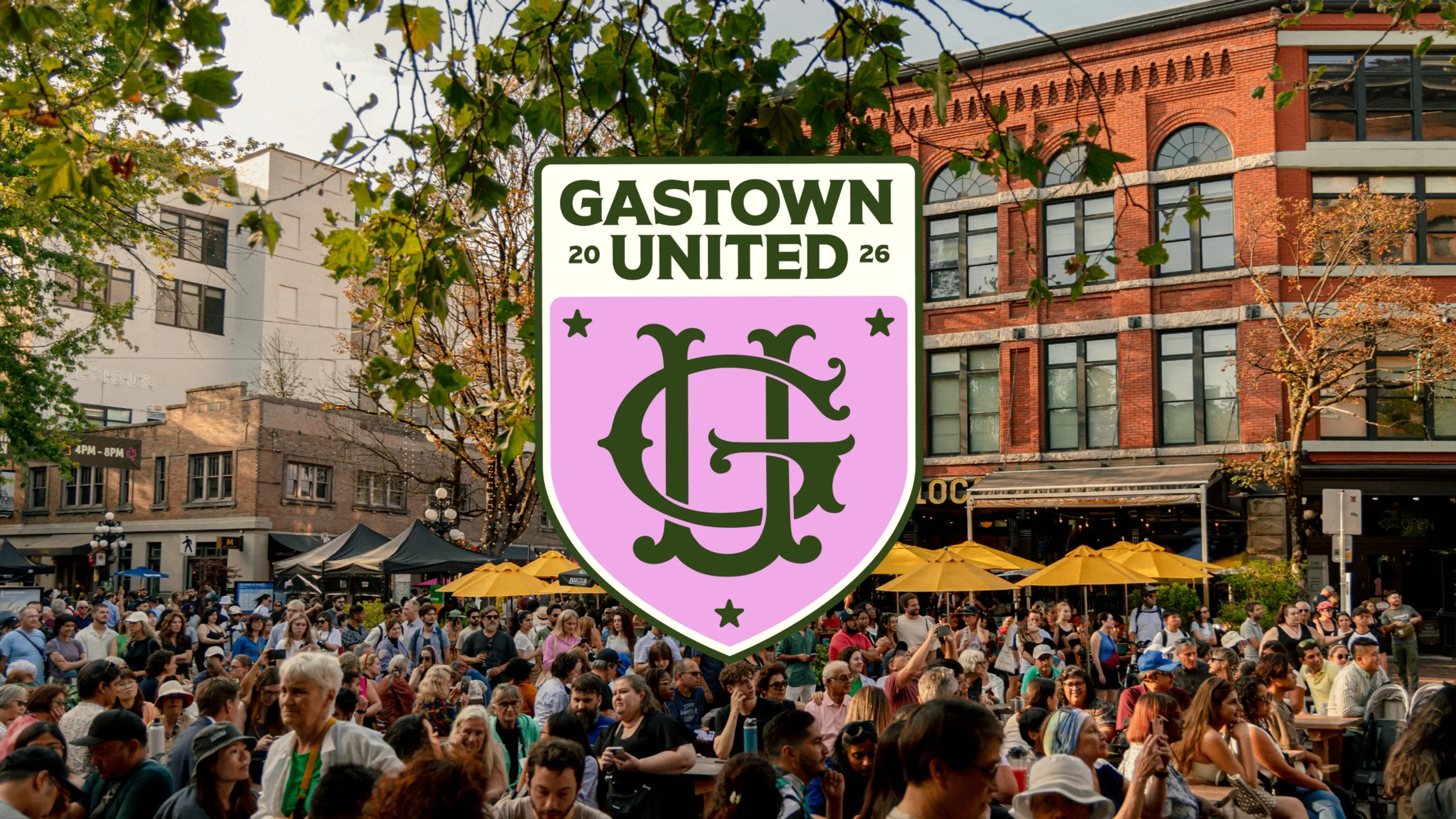 Large crowd gathered outdoors in a city area with trees and brick buildings, overlaid with a pink and green Gastown United logo.
