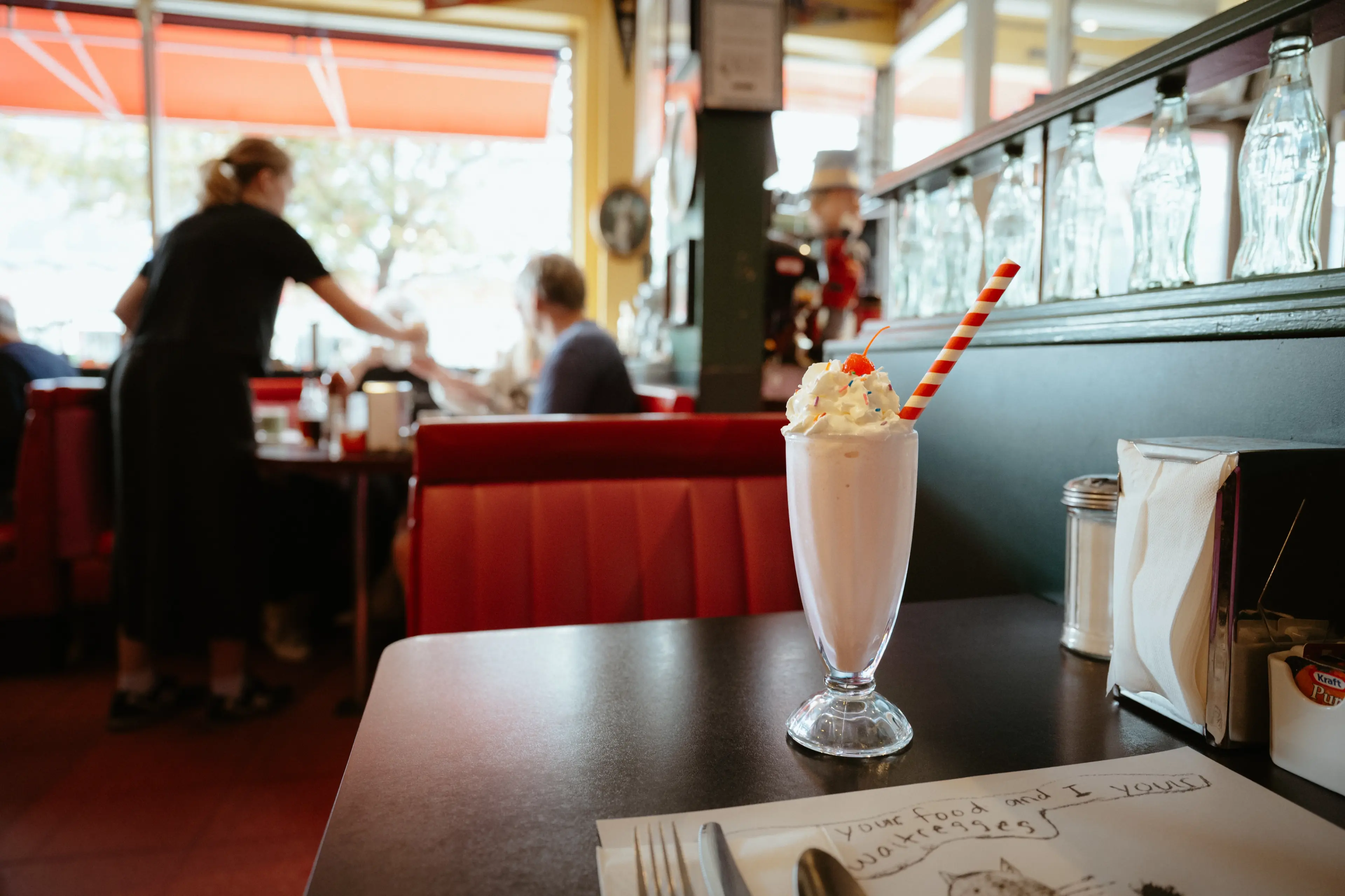 A milkshake decorated with a cherry and sprinkles at Sophie’s Cosmic Cafe in Kitsilano Vancouver.