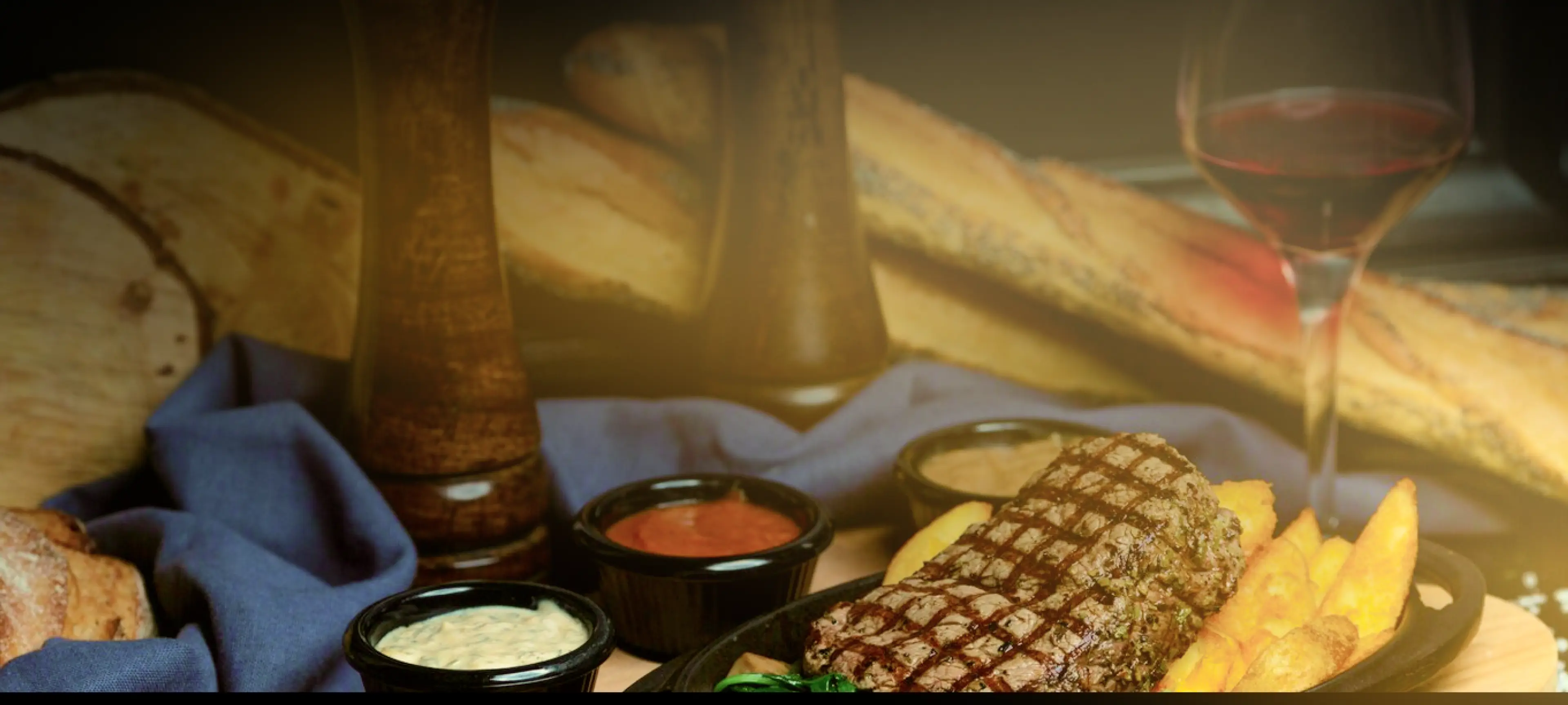 A steak and fries with sauces in a Vancouver restaurant