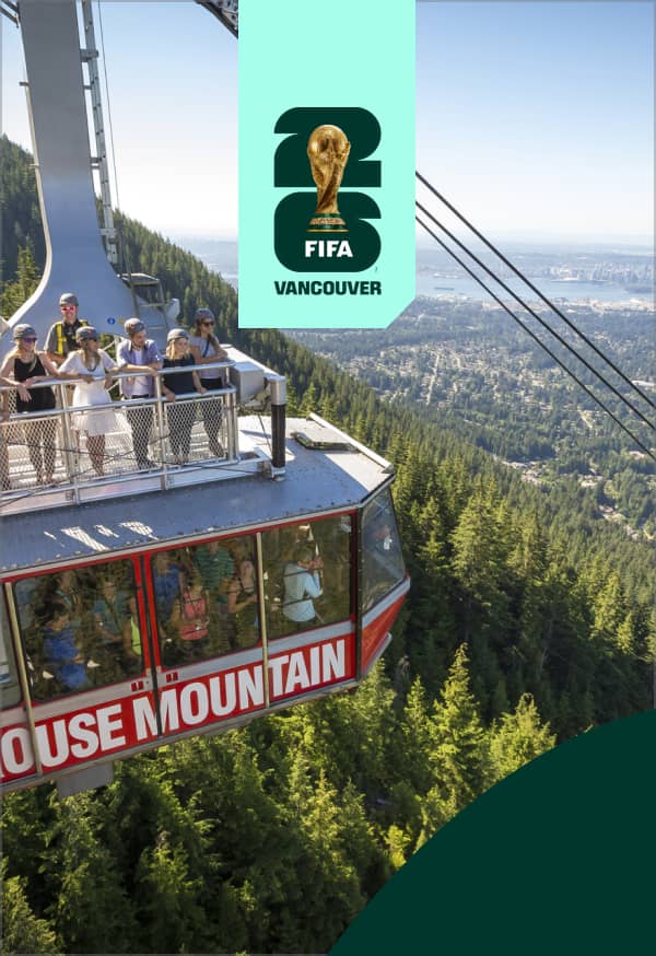 People wearing helmets on top and inside a Grouse Mountain cable car with a forest and city view in the background.