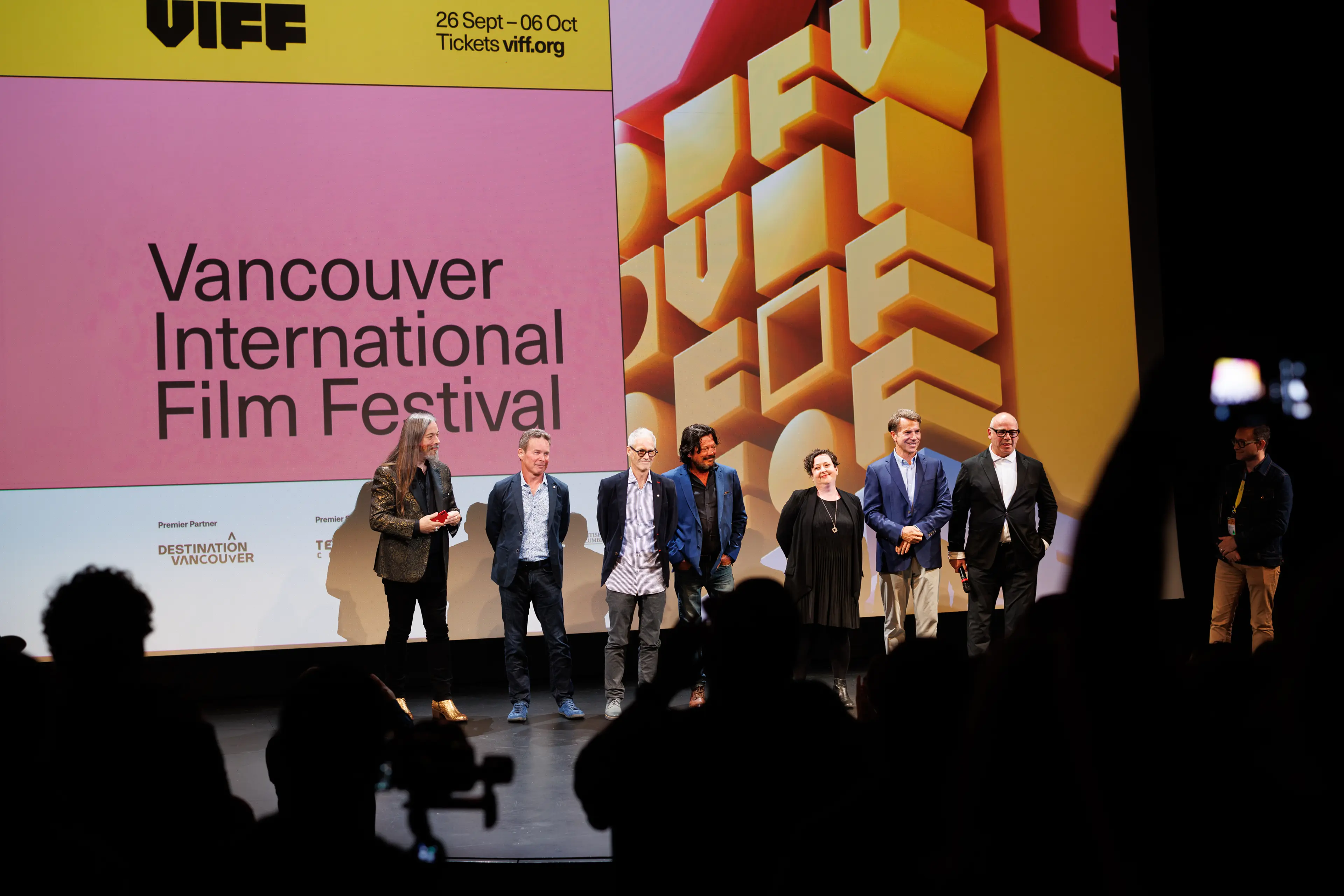 A group of people standing on stage at the Vancouver International Film Festival.