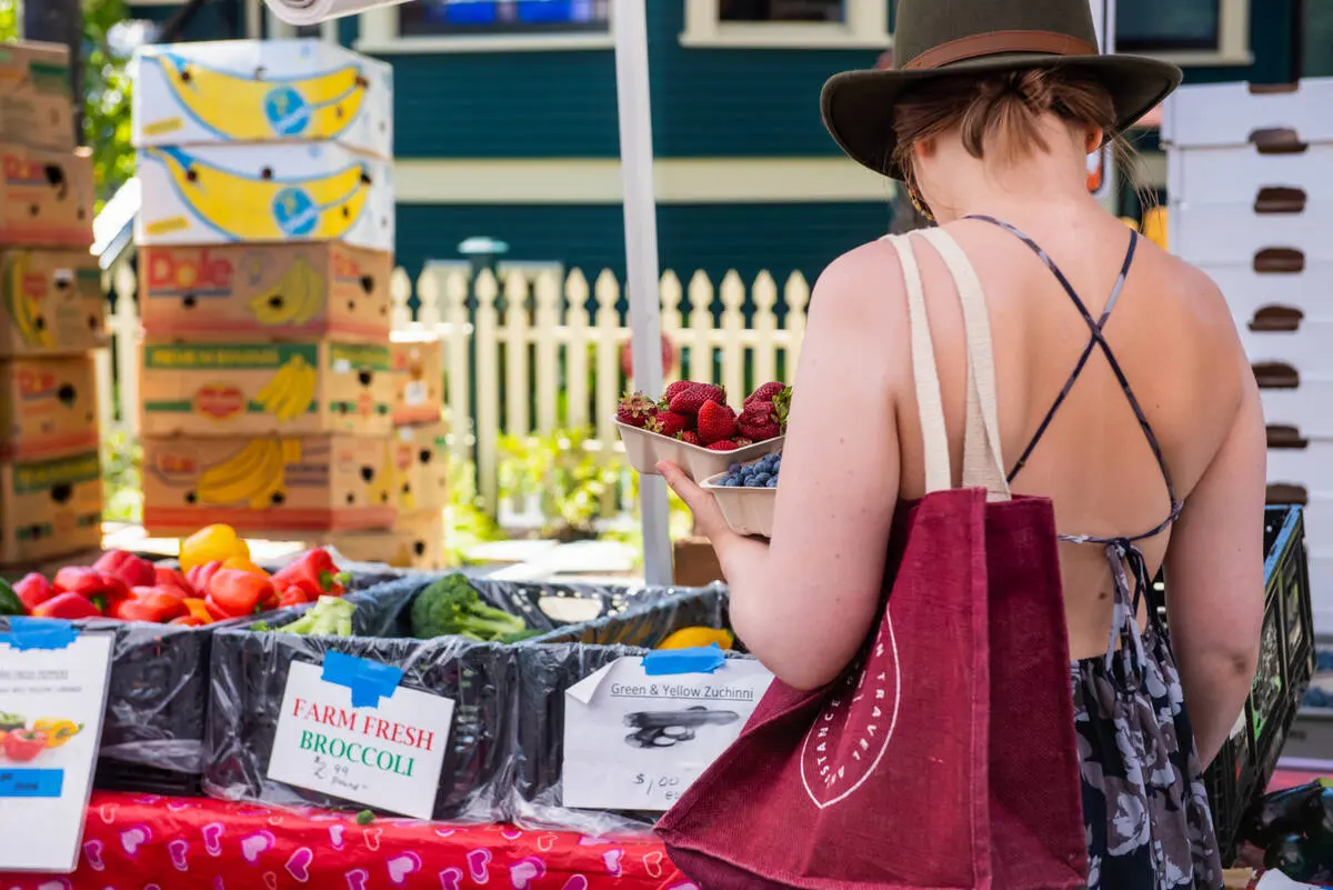 A women shops for produce at a farmer's market