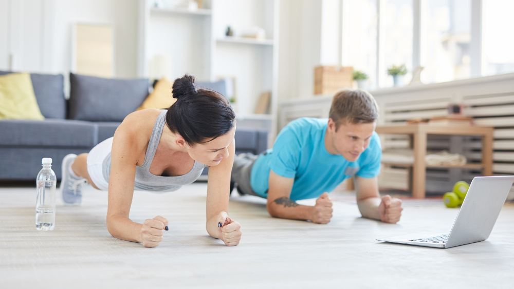 Couple working out at home. Workout at home online yoga classes in Vancouver