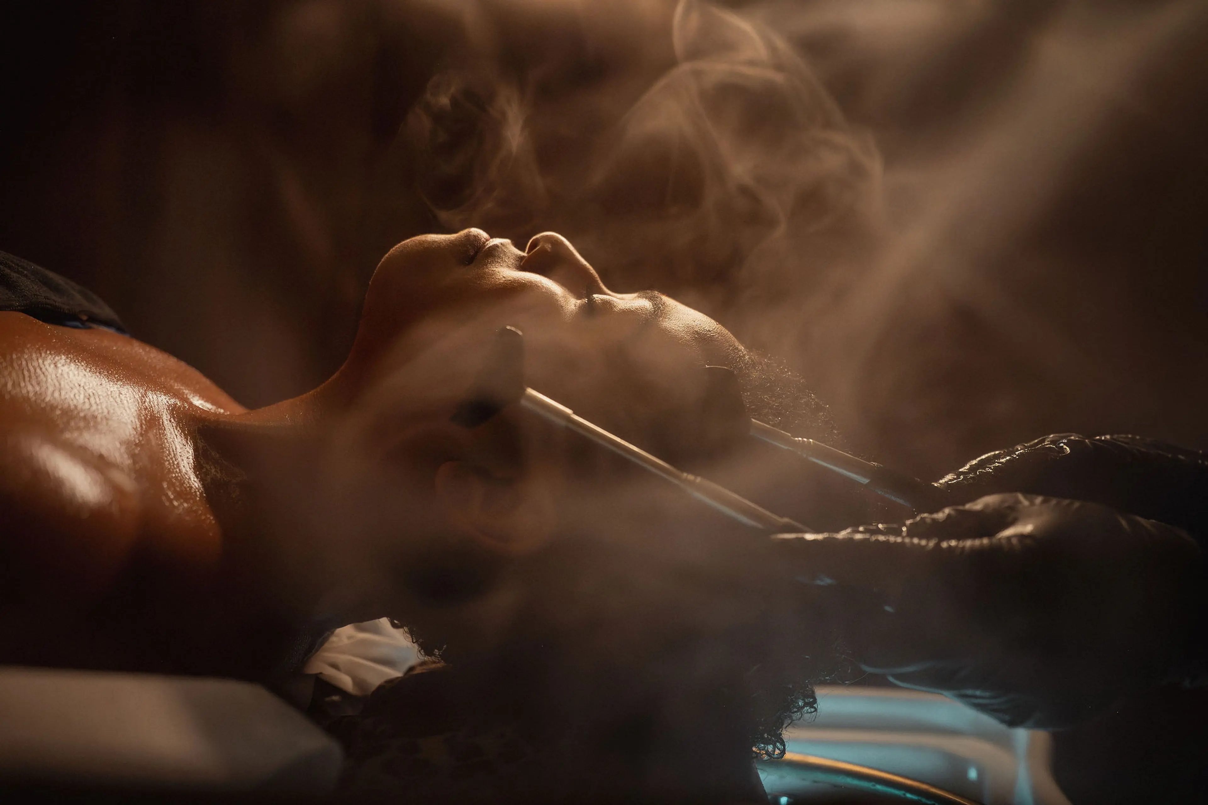 A person getting a head massage treatment at Headicure Head Spa with steam surrounding the client.