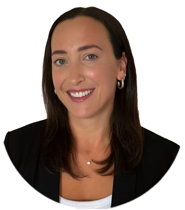 Person with shoulder-length dark hair, wearing gold hoop earrings, a black blazer, and a white top, smiling.