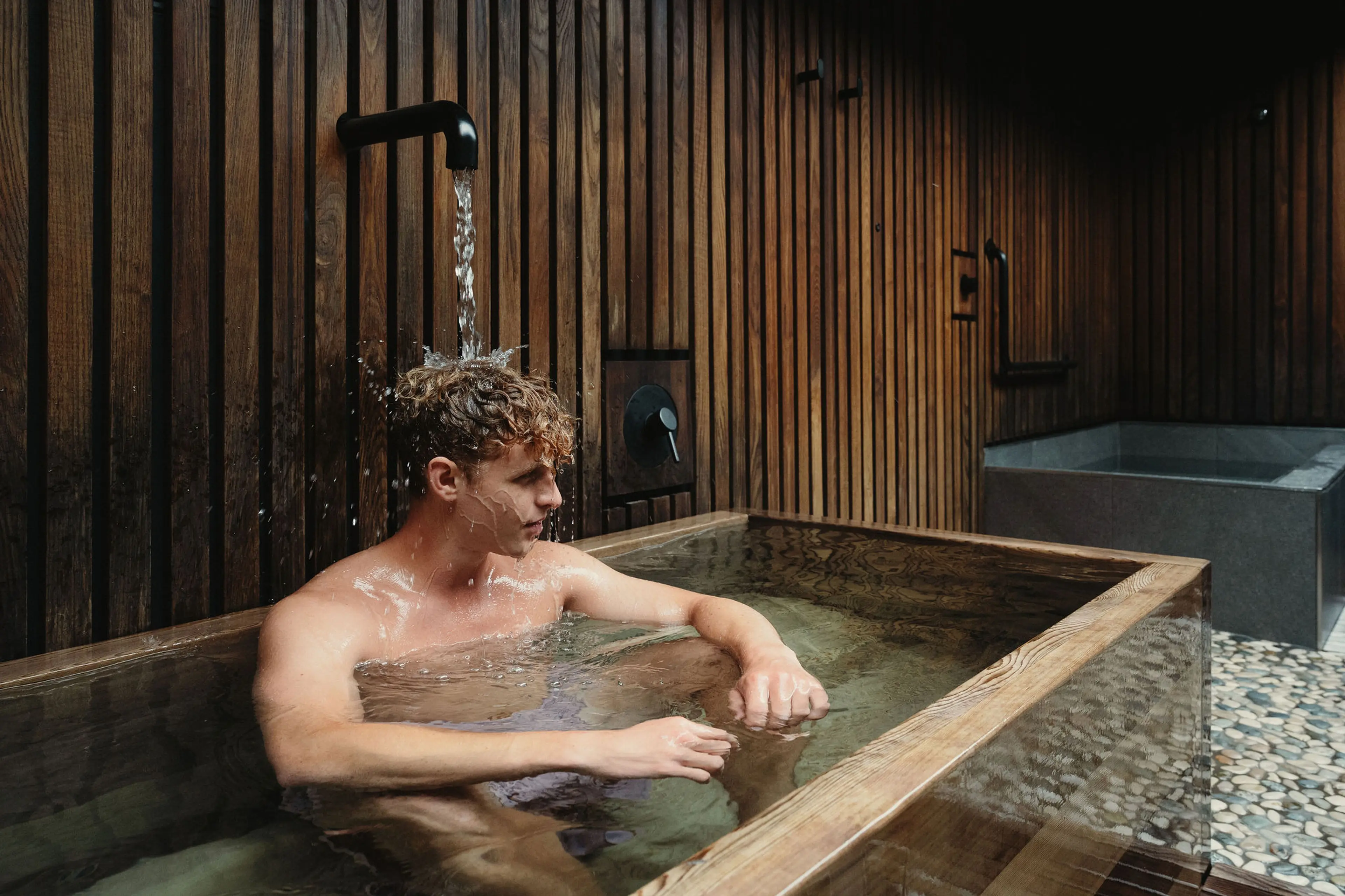 A person sitting in a tub at the Circle Wellness Spa in Vancouver.