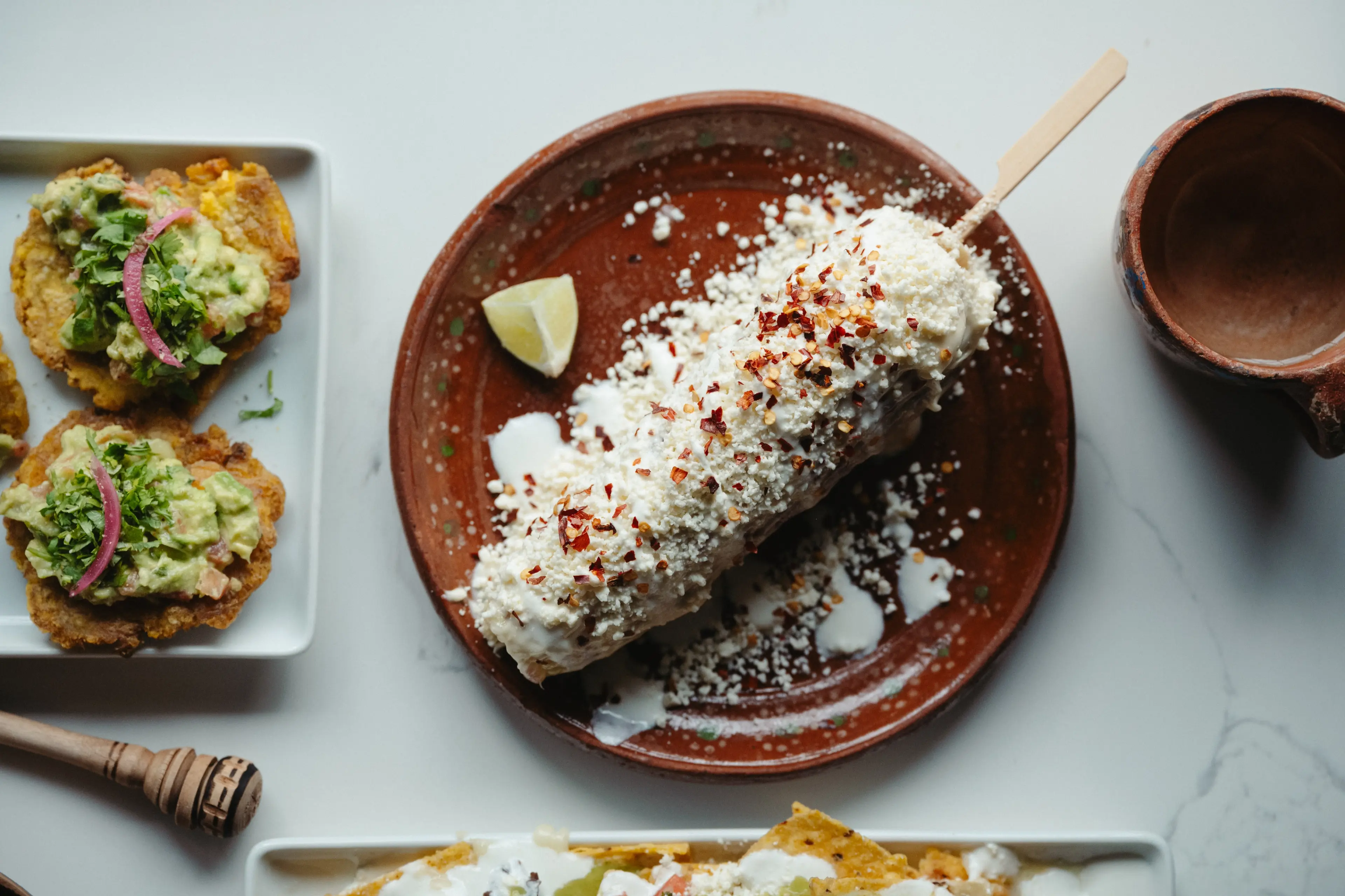 Elote dish, a whole corn rolled in chilli, lime, mayo, and queso fresco at Machete Ancestral Mexican Food in Vancouver.