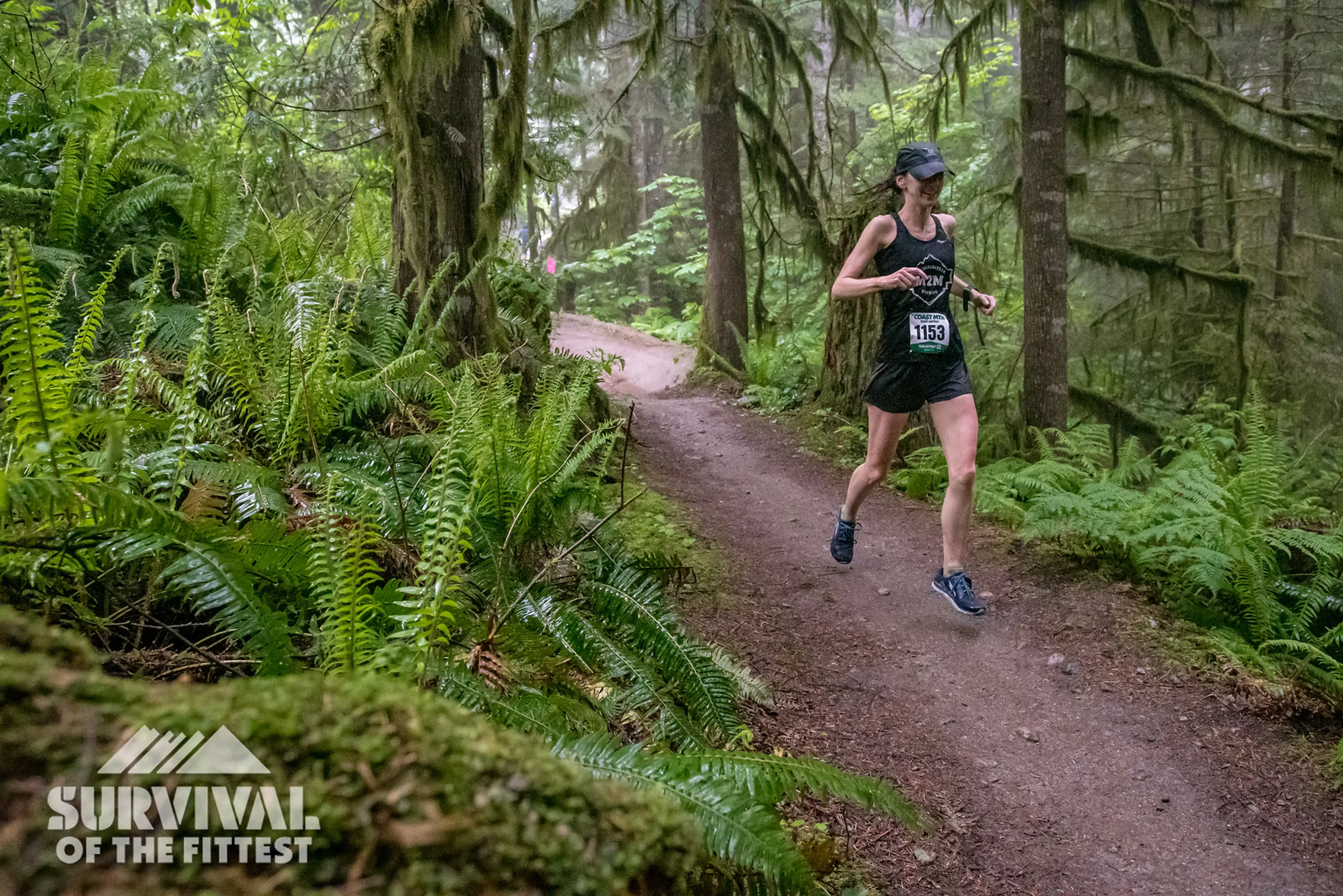 A female runner on a forested trail during the Survival of the Fittest trail running race in Squamish