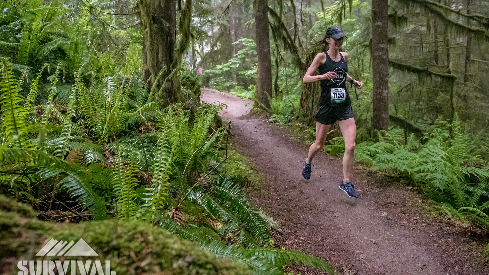 A female runner on a forested trail during the Survival of the Fittest trail running race in Squamish