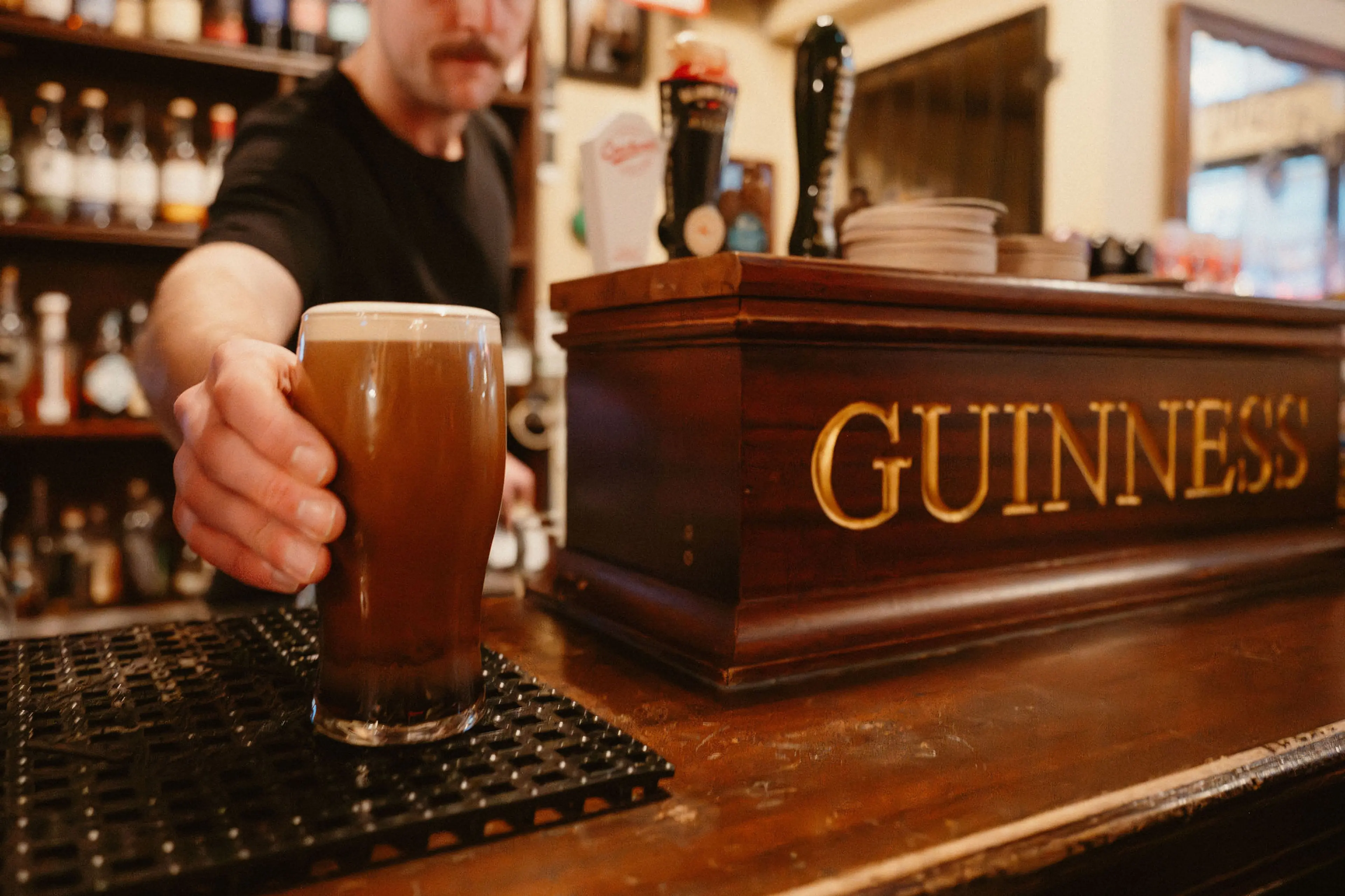 A person serving a Guinness beer on at the The Irish Heather Shebeen Pub in Vancouver.