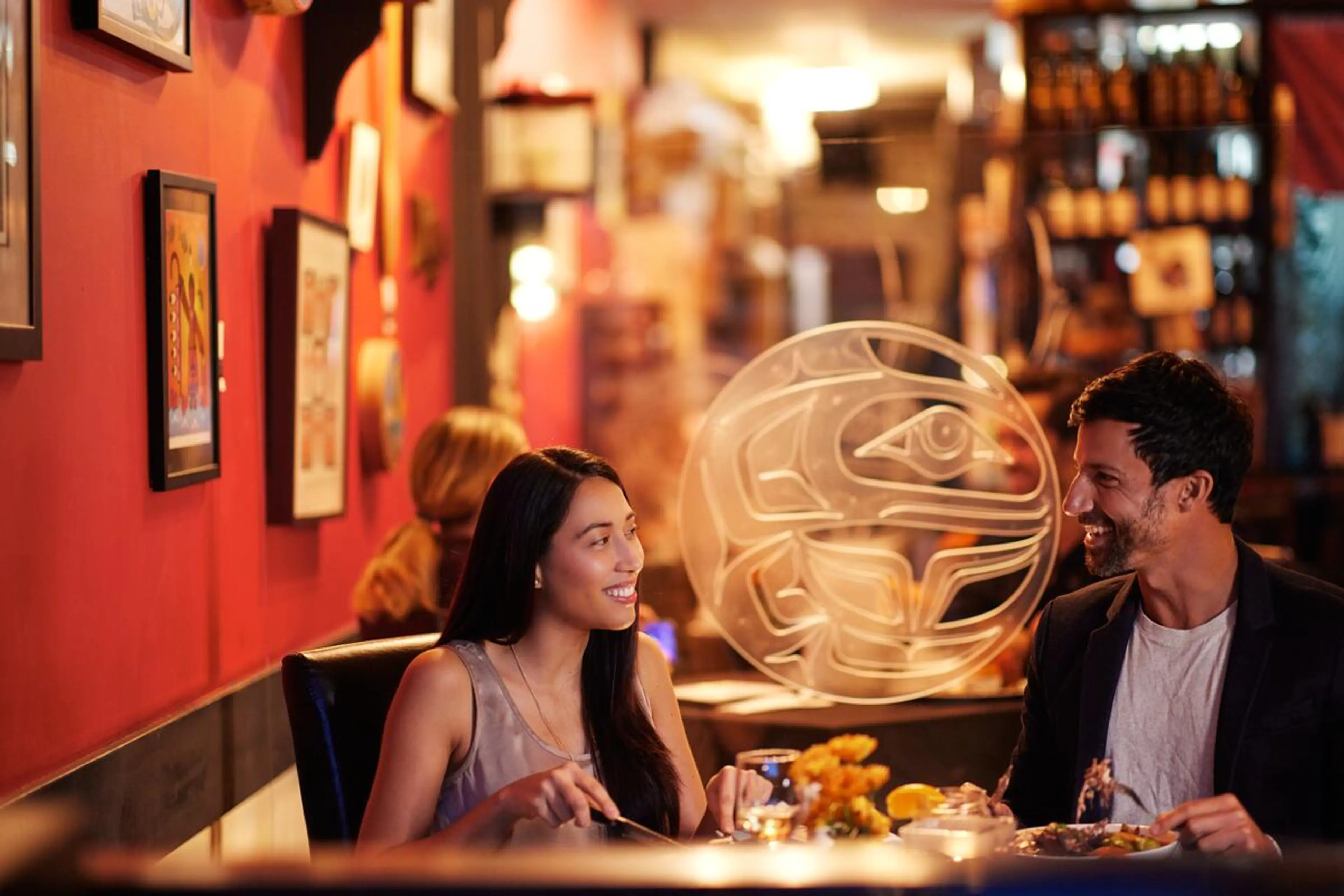 Two people dining at the restaurant Salmon N Bannock in Vancouver.