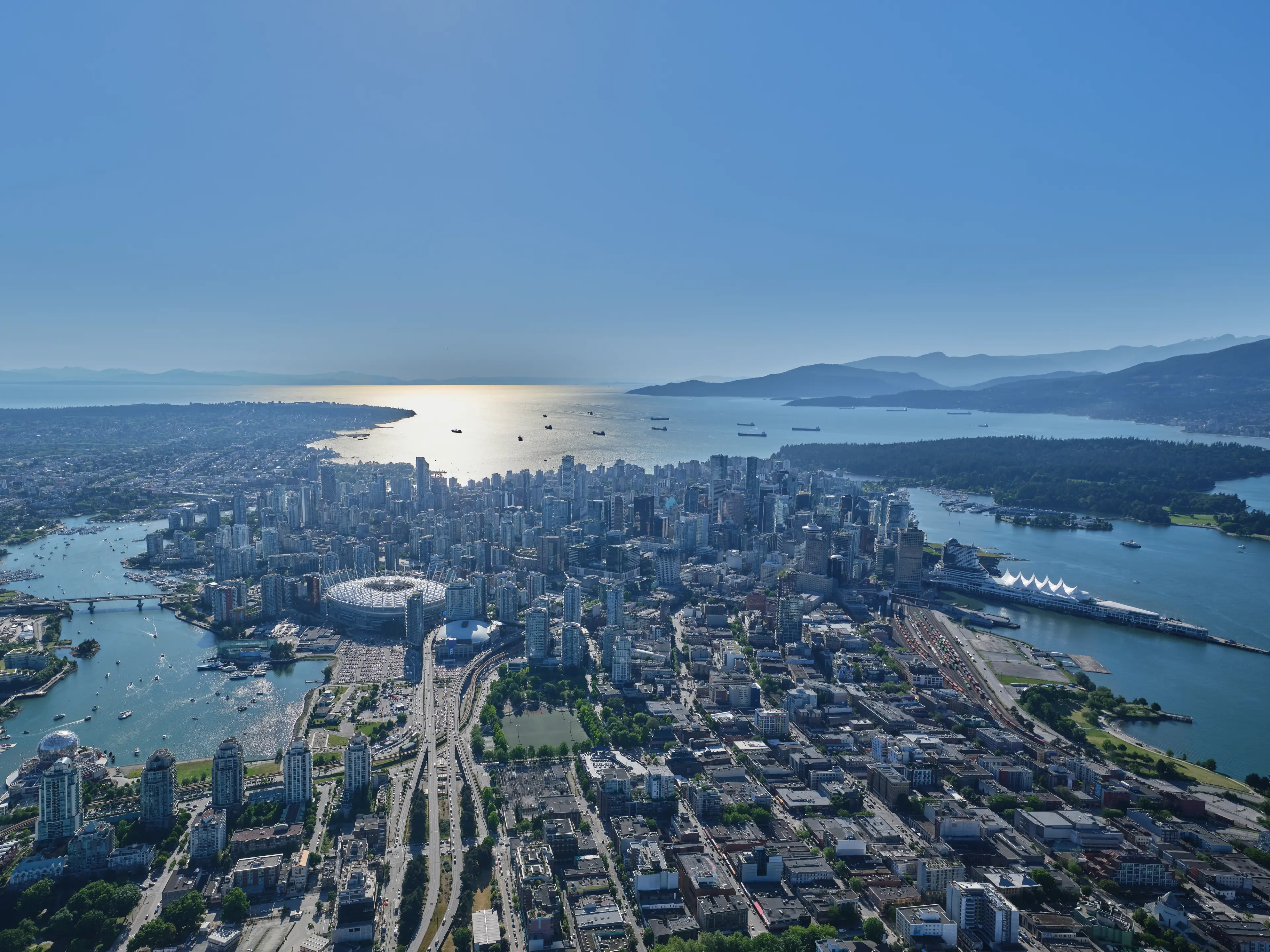 Aerial view of Vancouver looking out to the ocean and mountains.