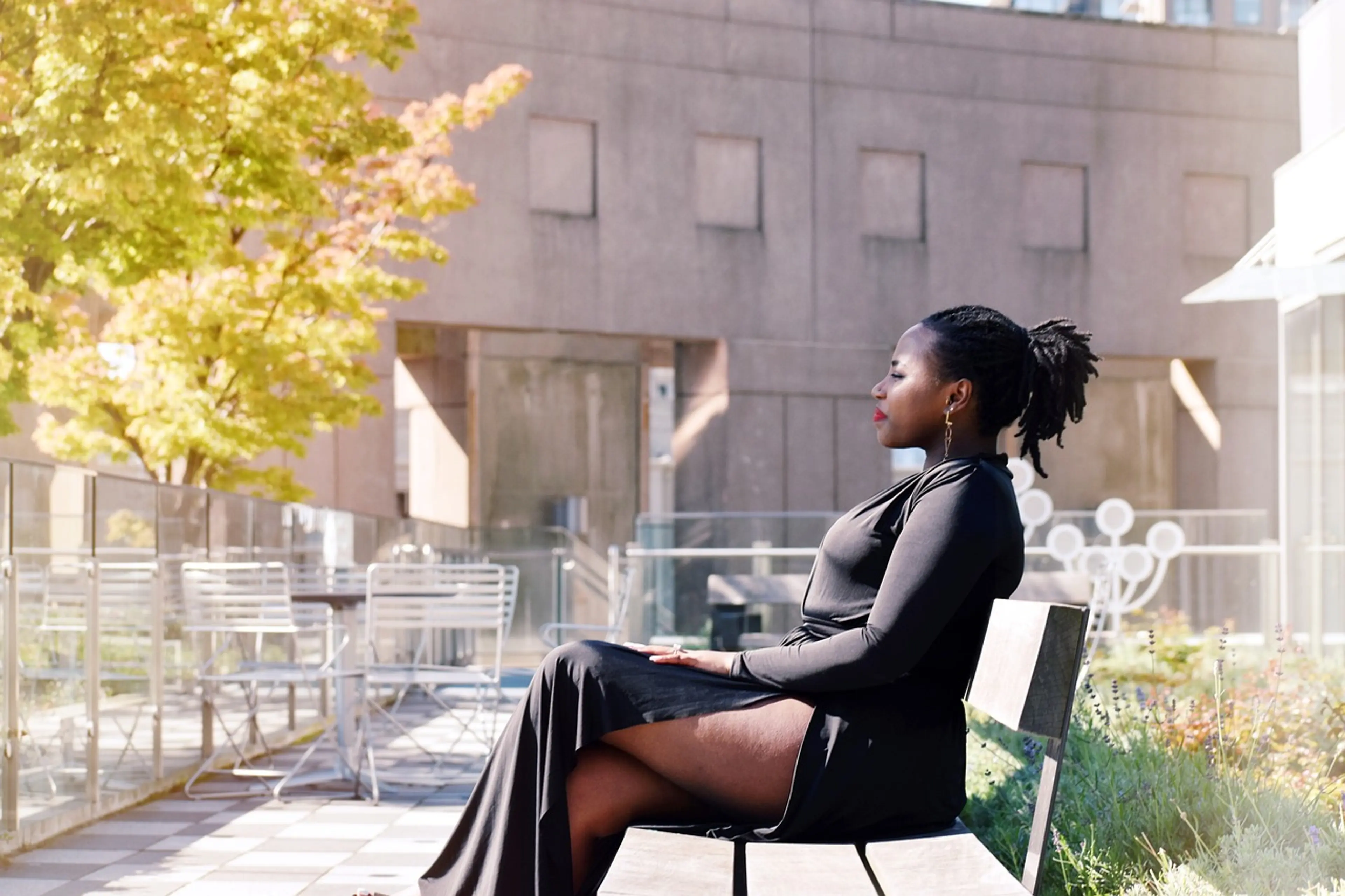 A woman sits on a bench in the rooftop garden at the Vancouver Central Library