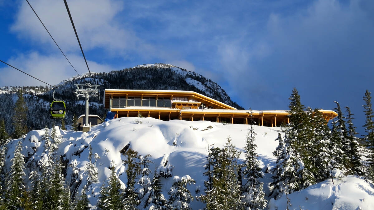 The lodge at the top of the Sea to Sky Gondola covered in snow.