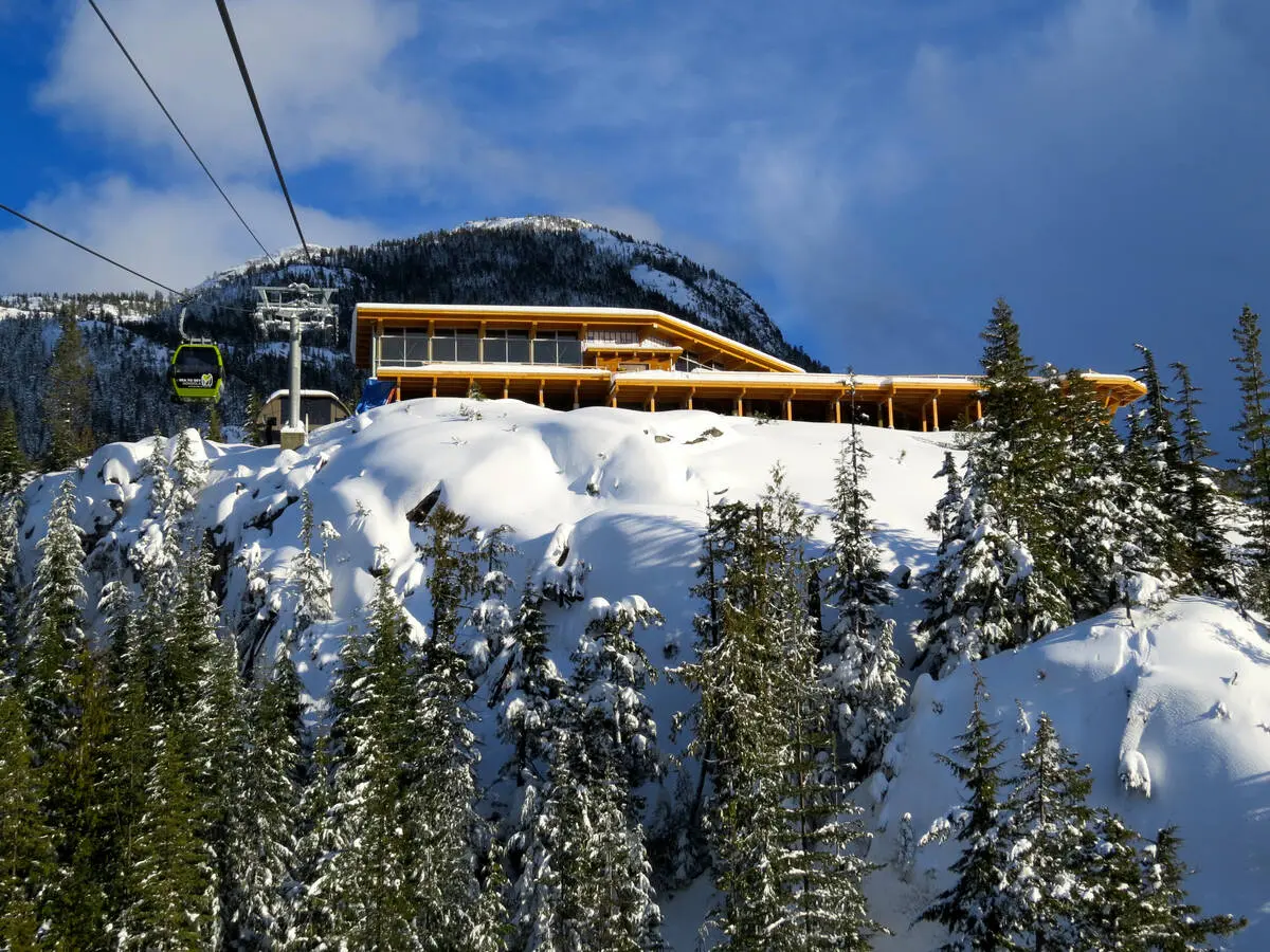 The lodge at the top of the Sea to Sky Gondola covered in snow.