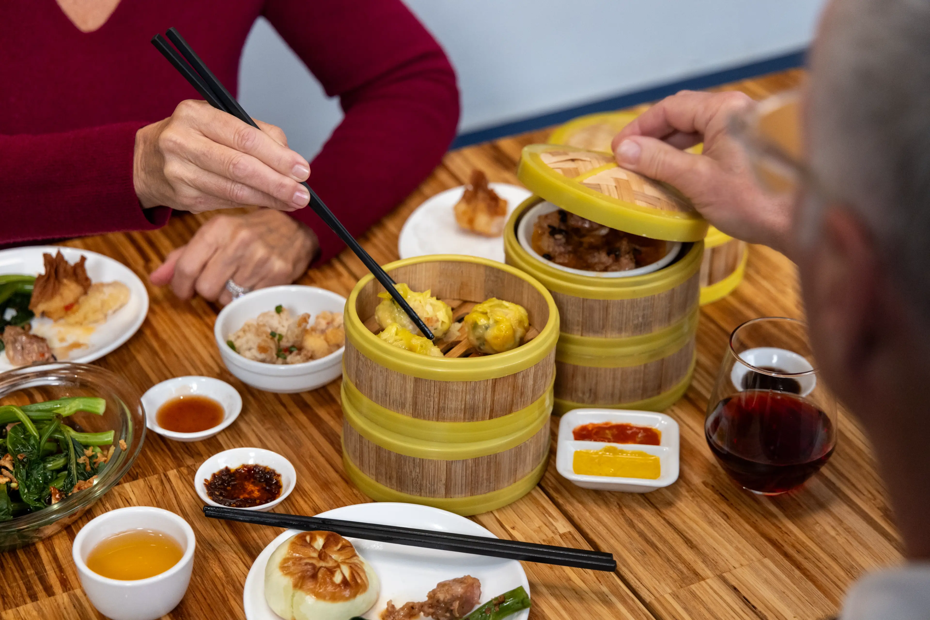 A table with multiple dishes at Little Bird Dim Sum in Vancouver.