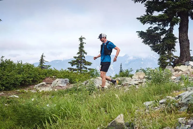 A runner on the Buckin' Hell trail running course at Mount Seymour