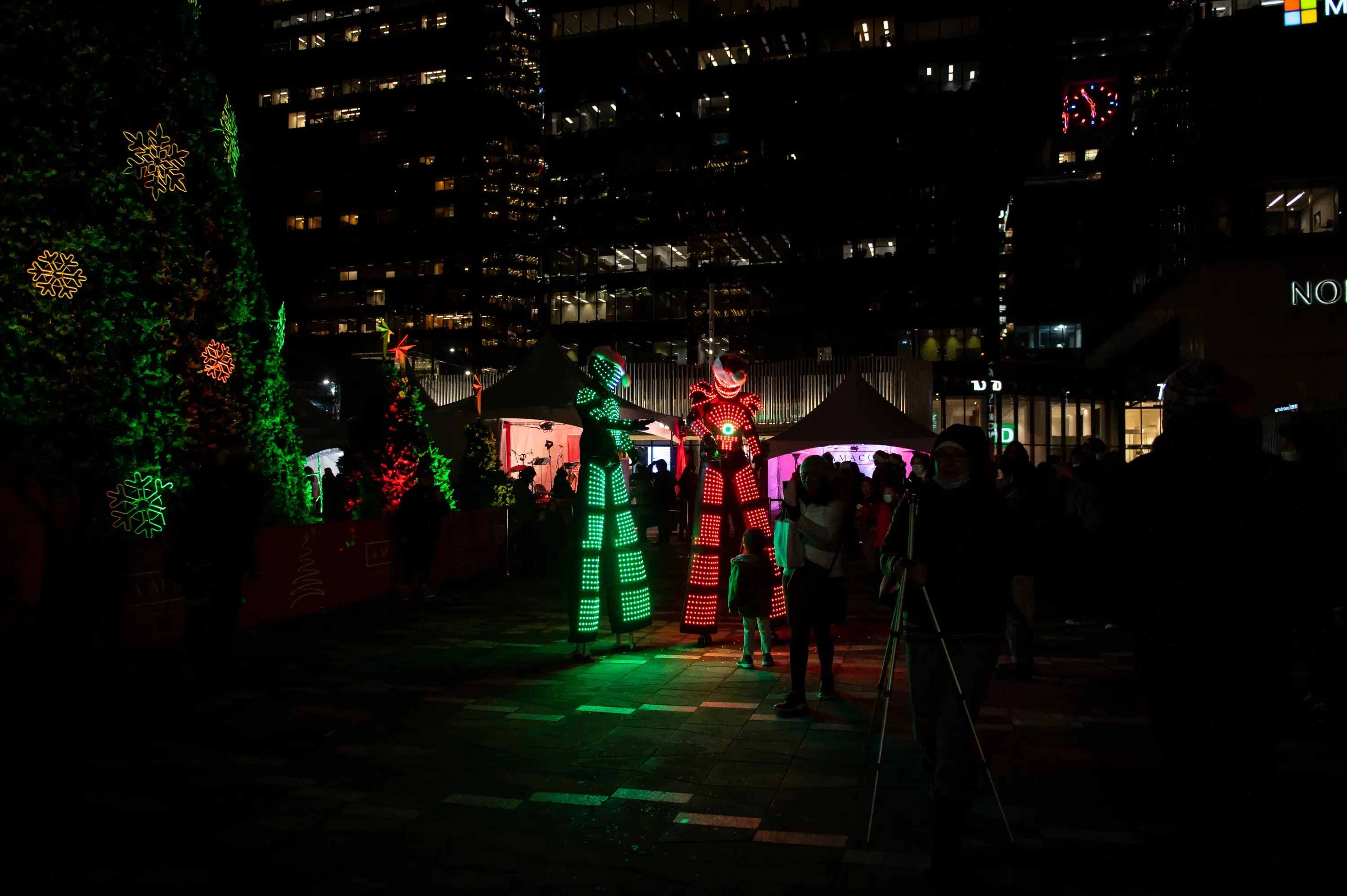 Performers on stilts interact with the crowd at the Vancouver Christmas Tree Lighting Celebration