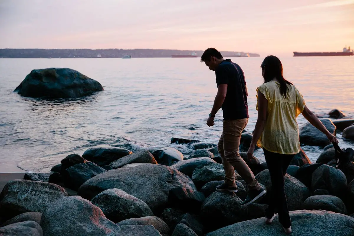 Two people at sunset at Third Beach in Vancouver
