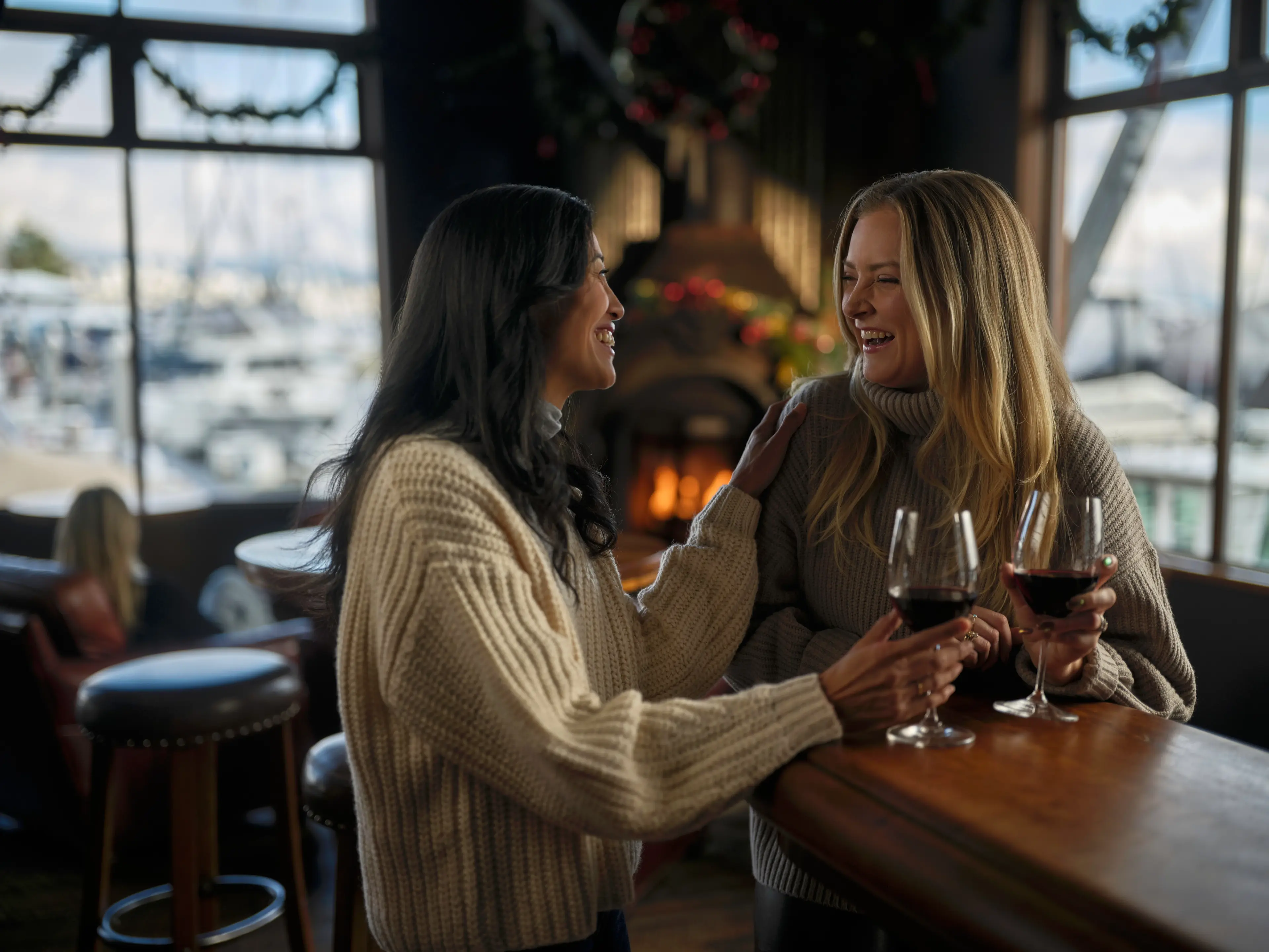 Two people drinking wine at Cardero's Restaurant in Coal Harbour, Vancouver..
