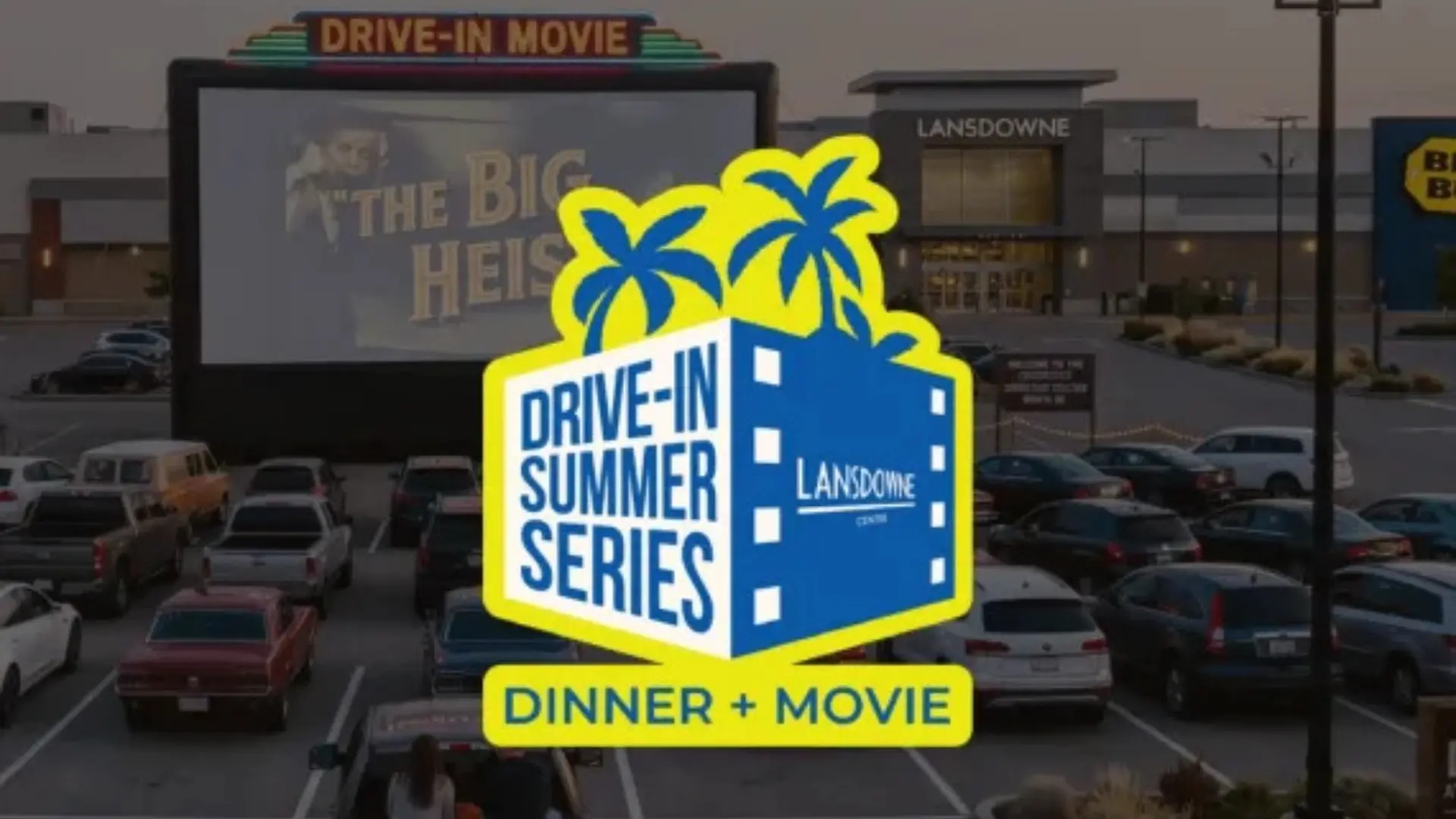 Drive-in movie event with cars parked facing a large screen showing The Big Heist, with a logo for Drive-In Summer Series Dinner + Movie at Lansdowne Centre.