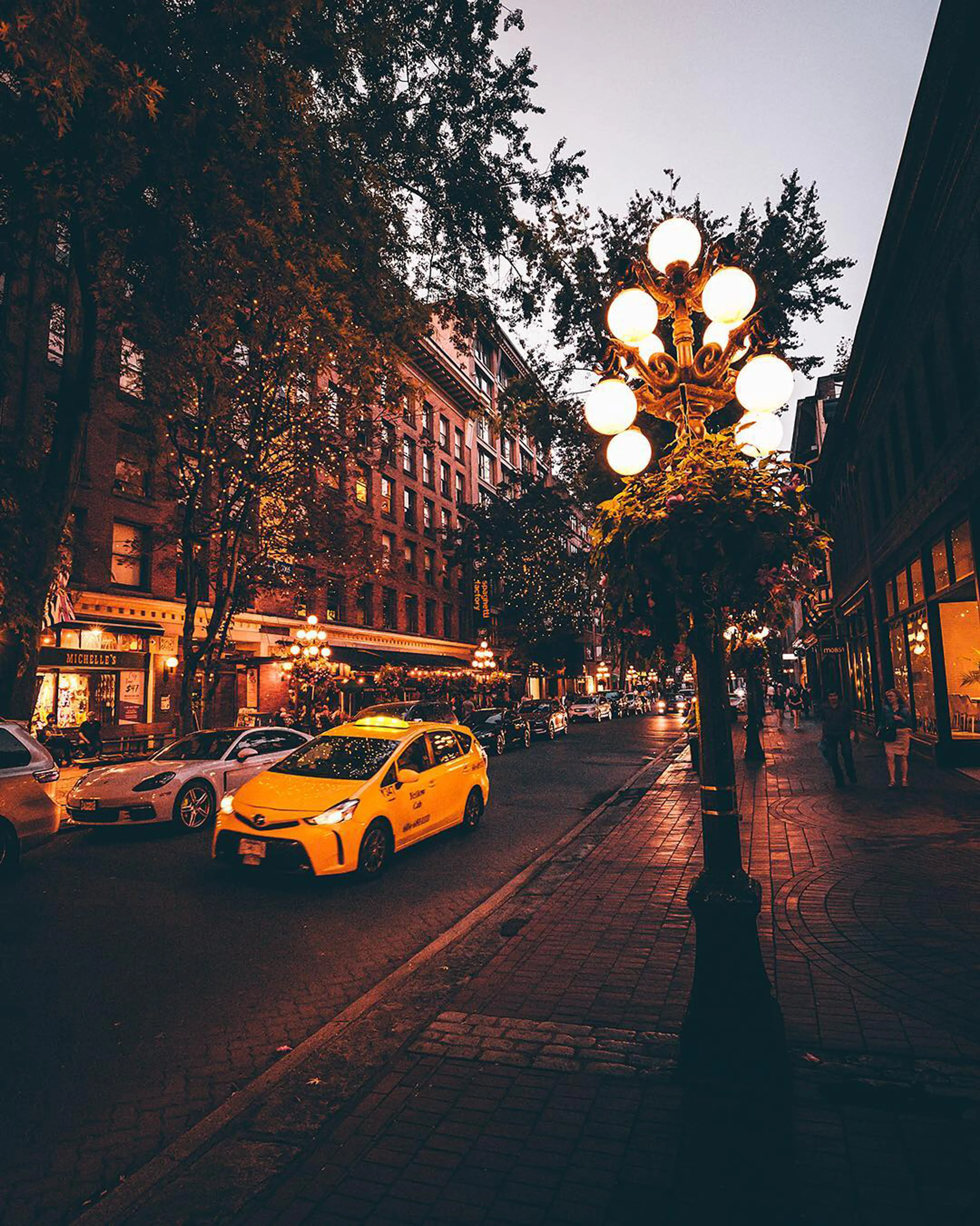 Taxi driving through Gastown at dusk