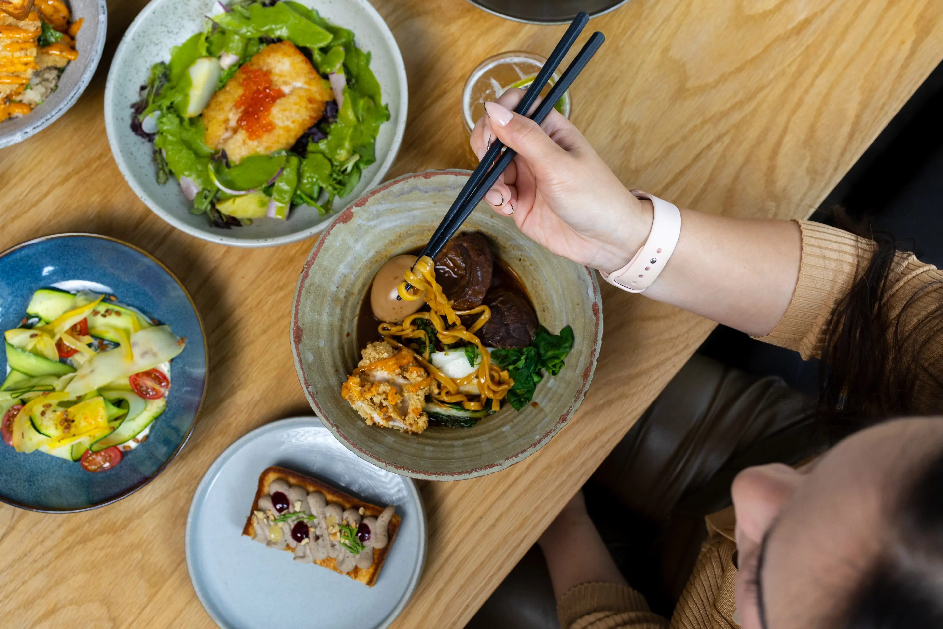 A bowl with ramen and other plates at Torafuku in Vancouver.