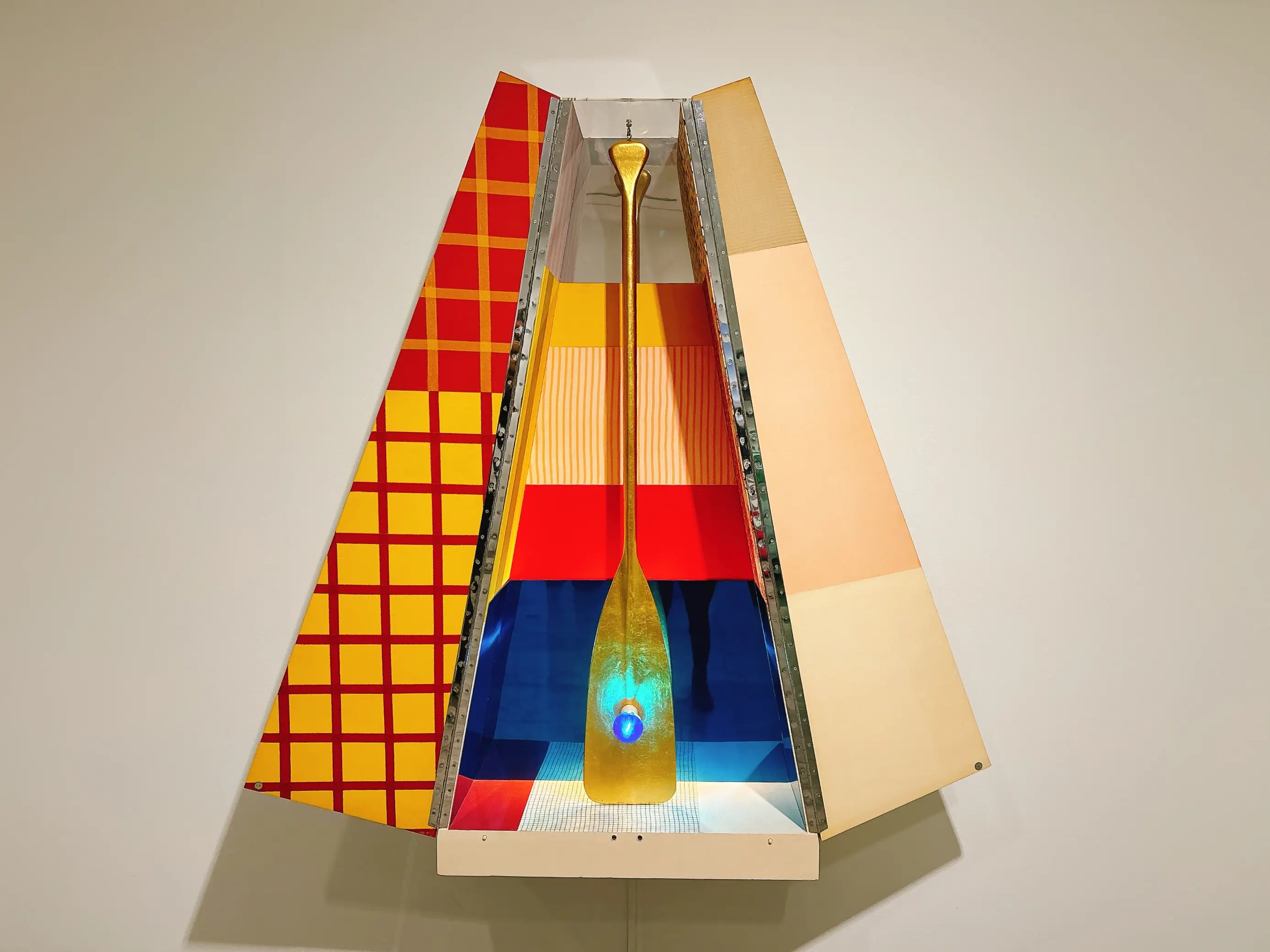 A work by Robert Rauschenberg that uses everyday objects like a paddle and a lightbulb to create a "shrine"