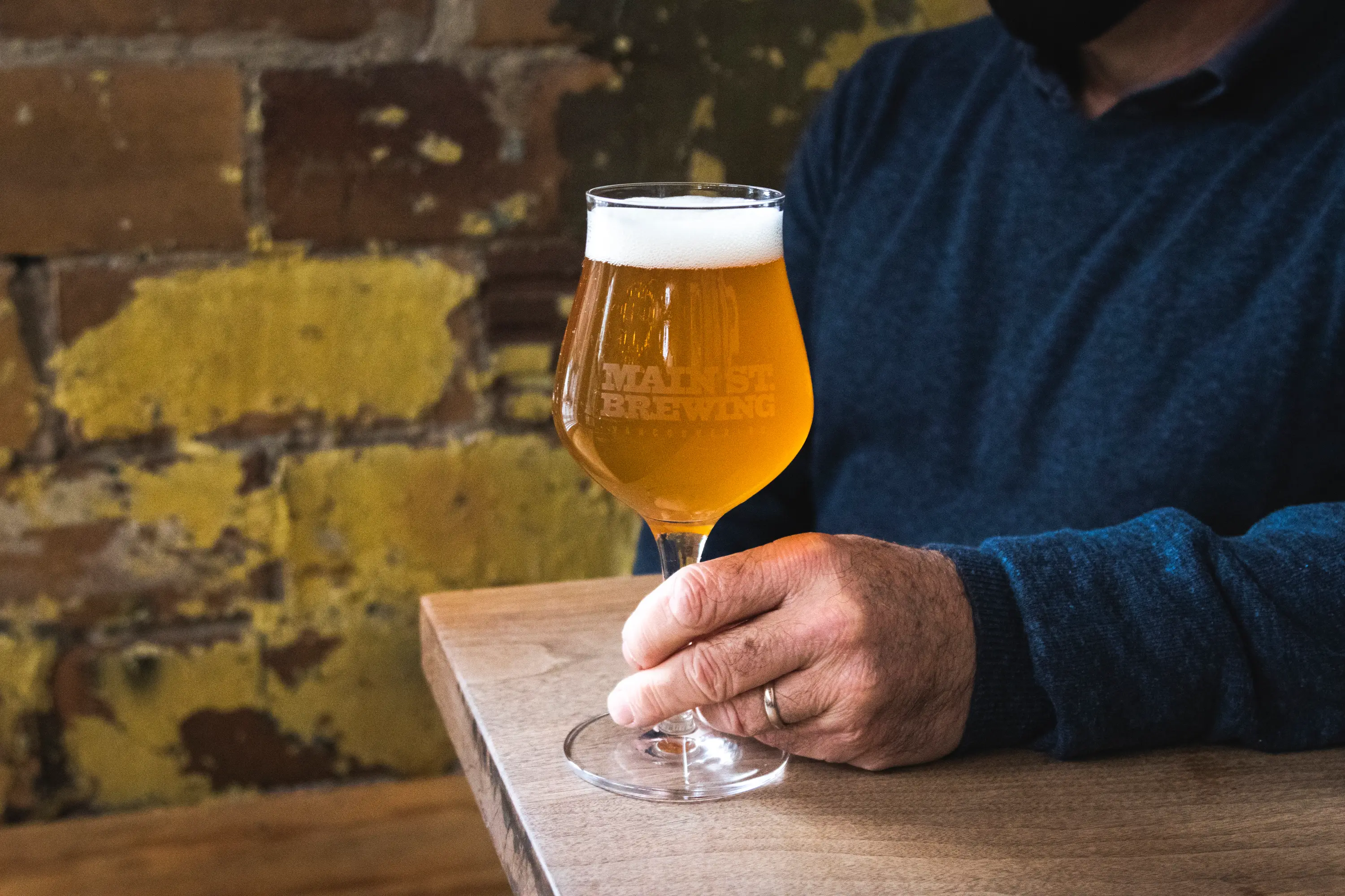 Someone holding their beer at Main Street Brewing