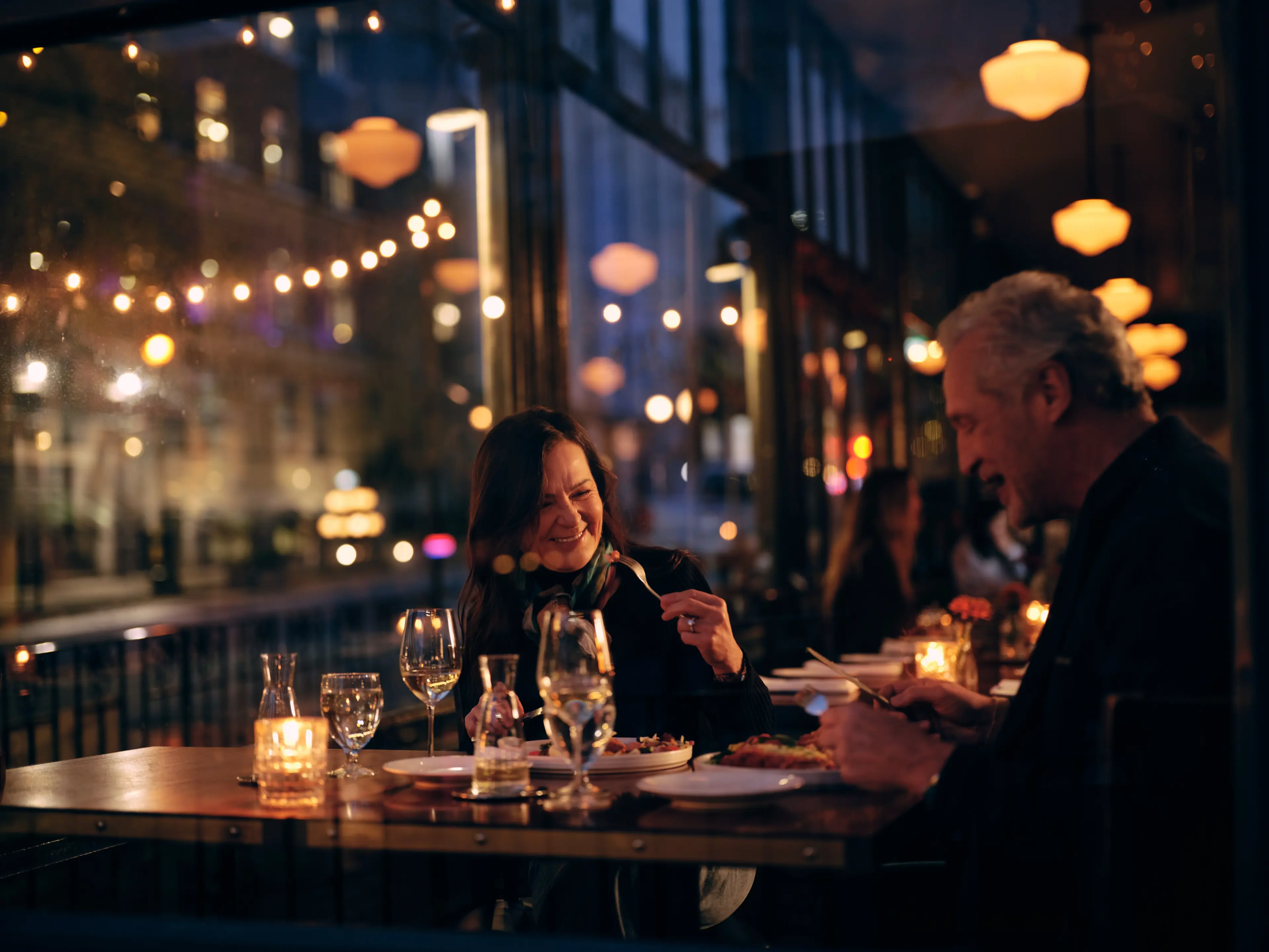 A couple dining at the Water Street Cafe in Gastown in Vancouver with romantic lighting.