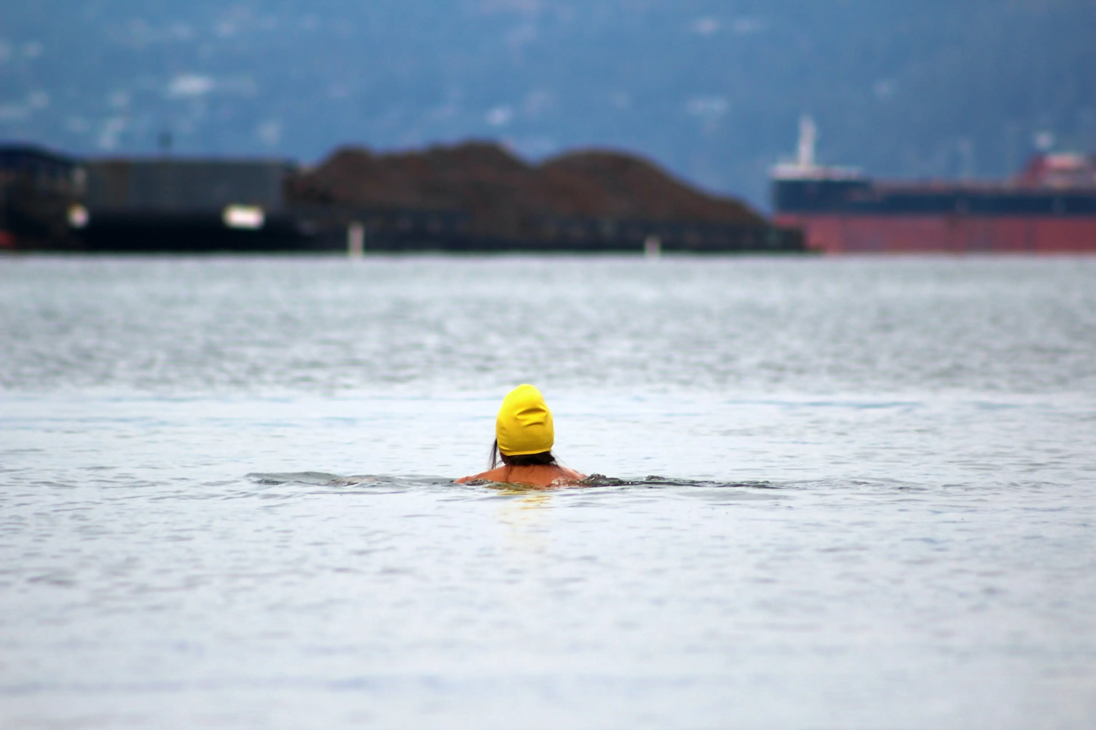 A woman swims in the ocean at Kits Beach in Vancouver