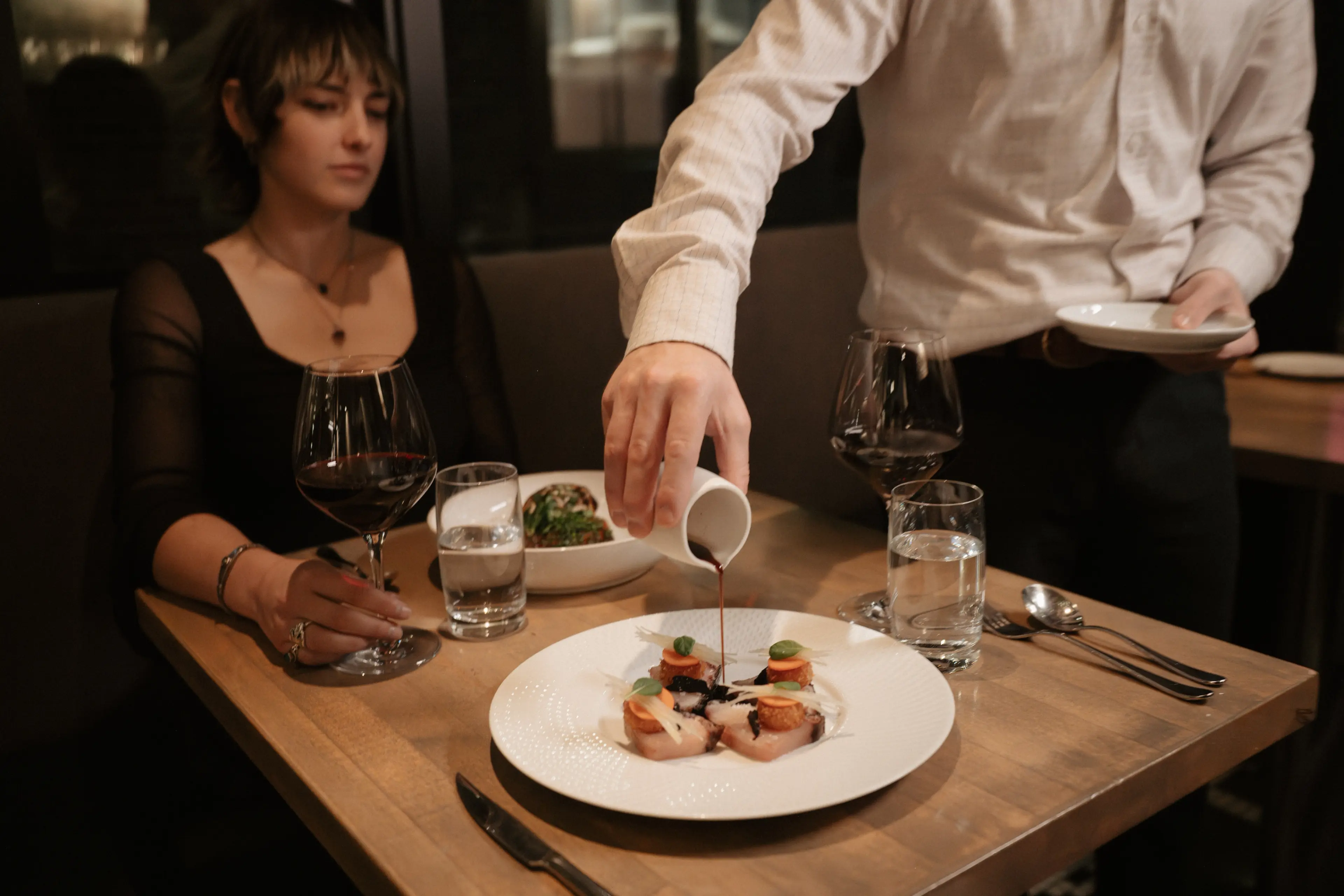 A person dining at L’Abattoir in Gastown, Vancouver.