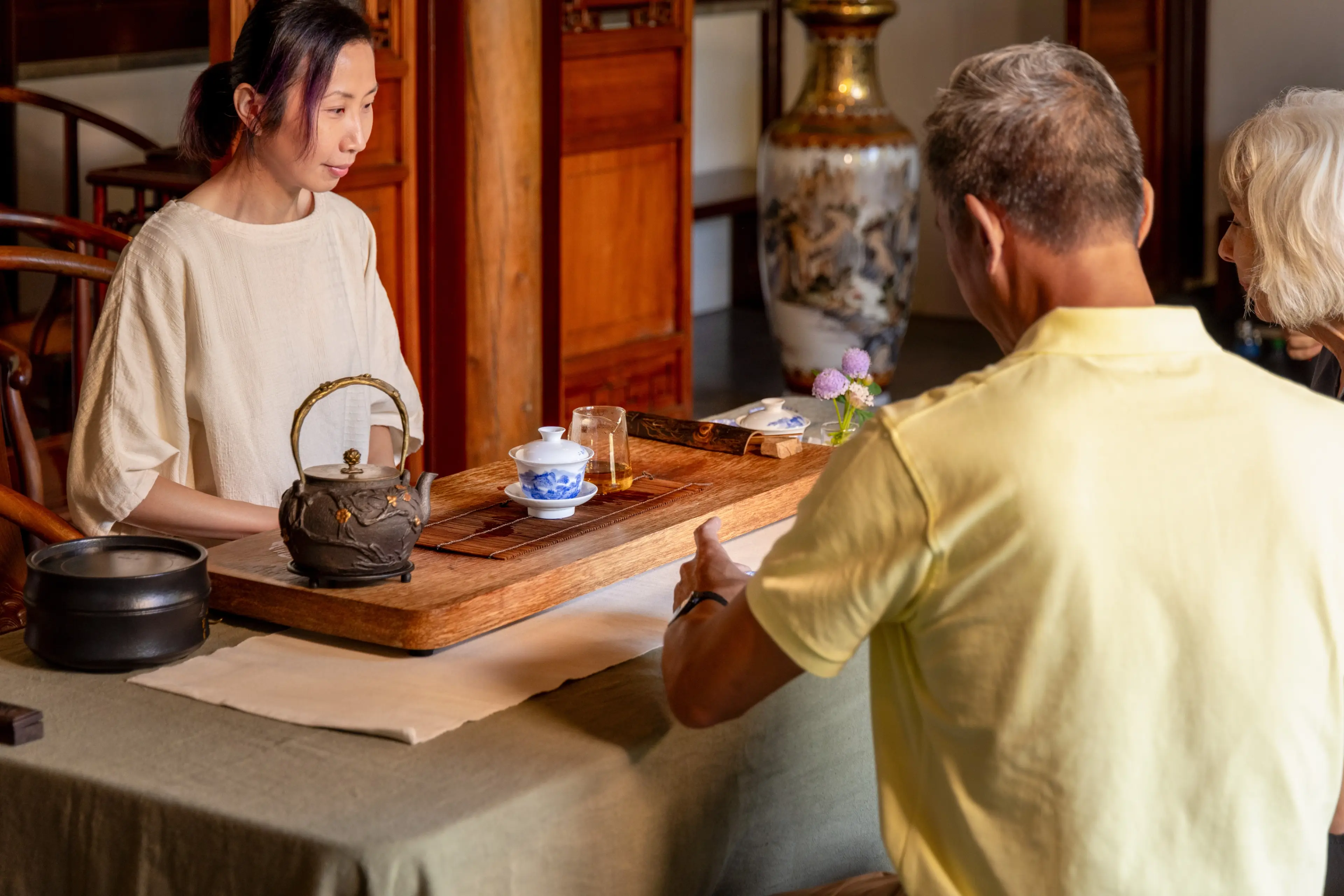 Two people receive tea at a tea ceremony at Dr. Sun Yat-Sen Classical Chinese Garden
