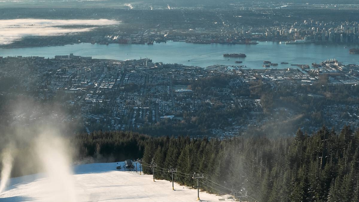 An aerial view of skiing at Grouse Mountain with the city in the background.