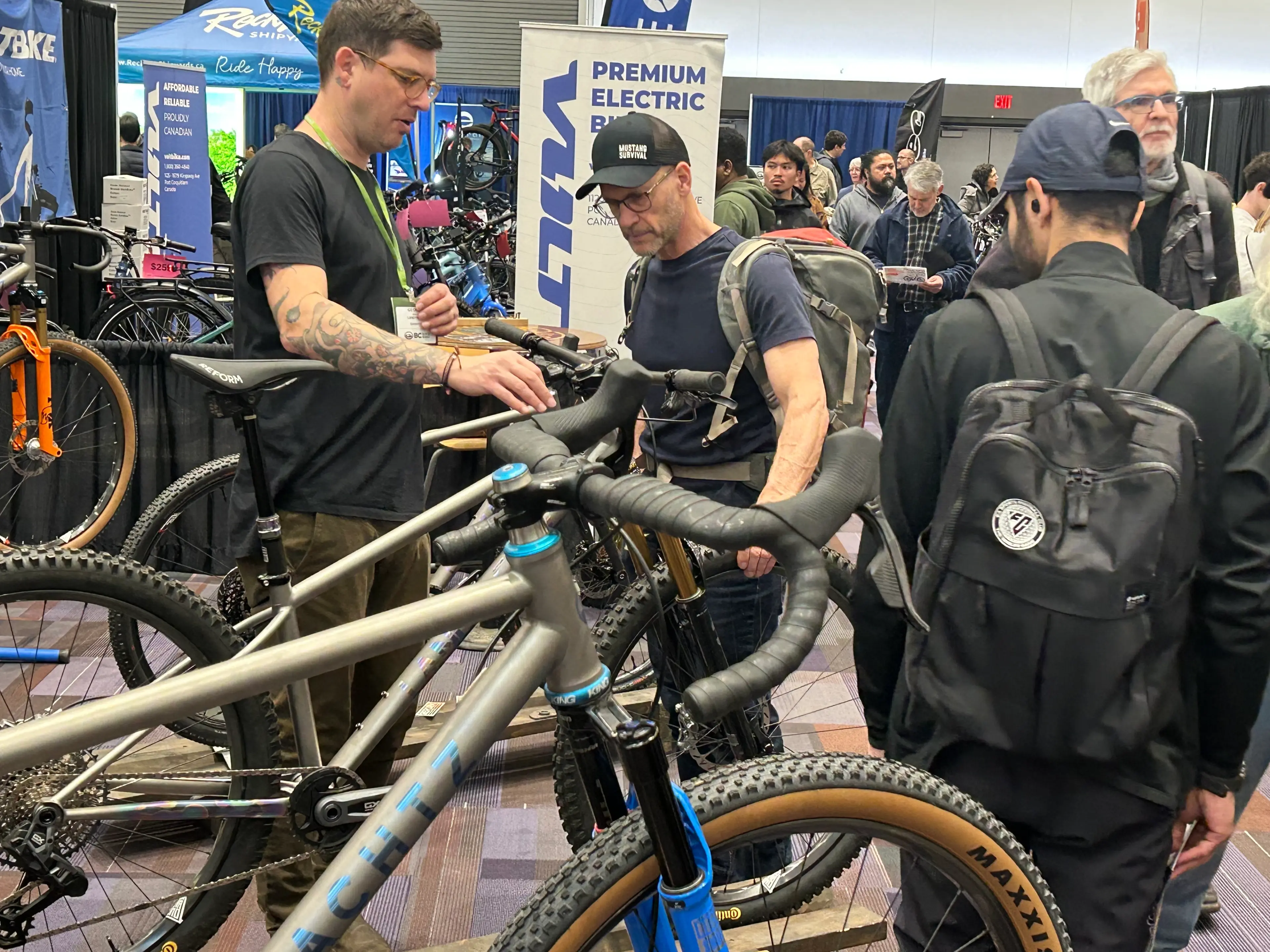 Two people standing around bikes at the BC Bike Show.