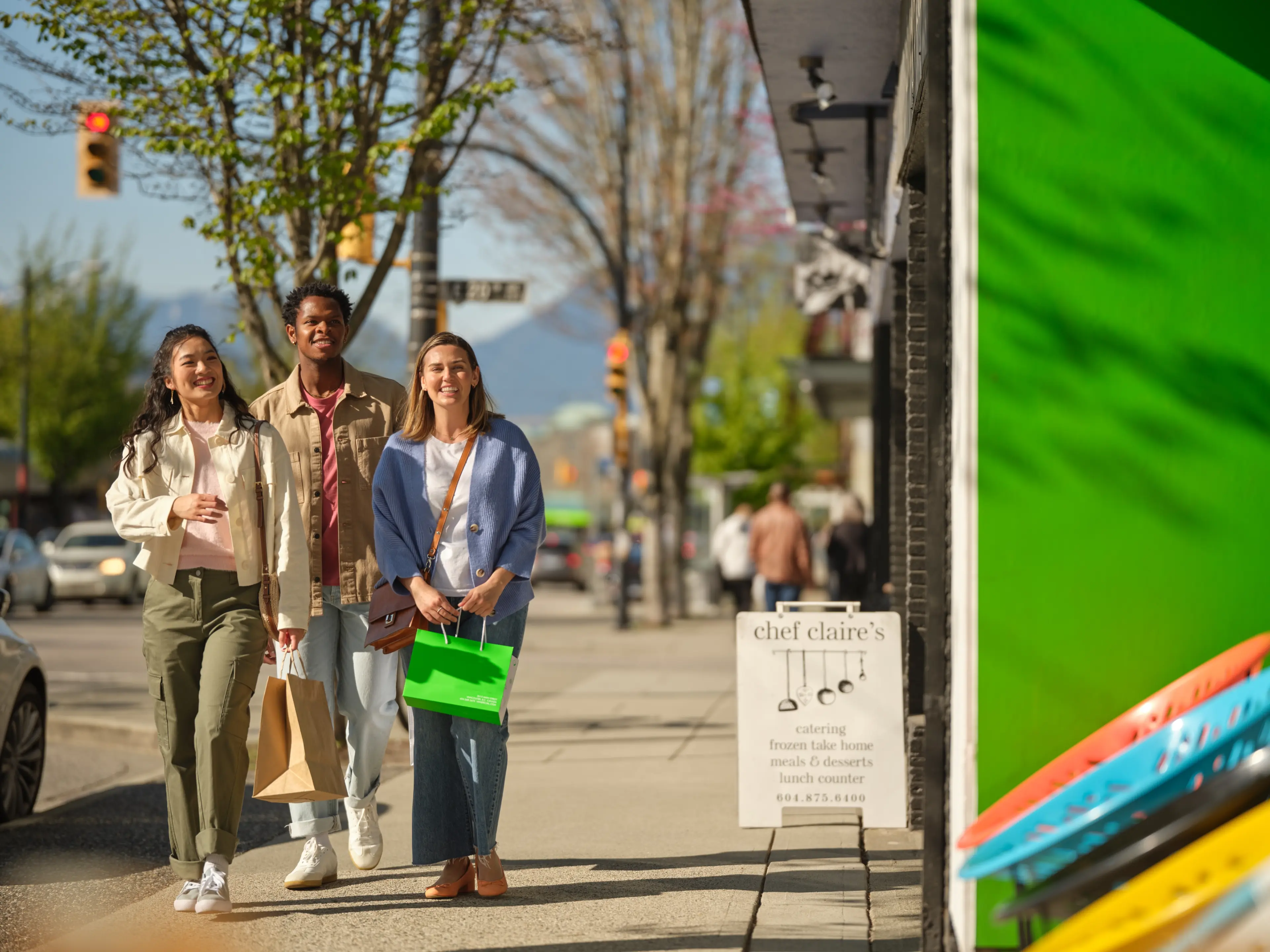 Three friends shopping in Mount Pleasant in Vancouver.