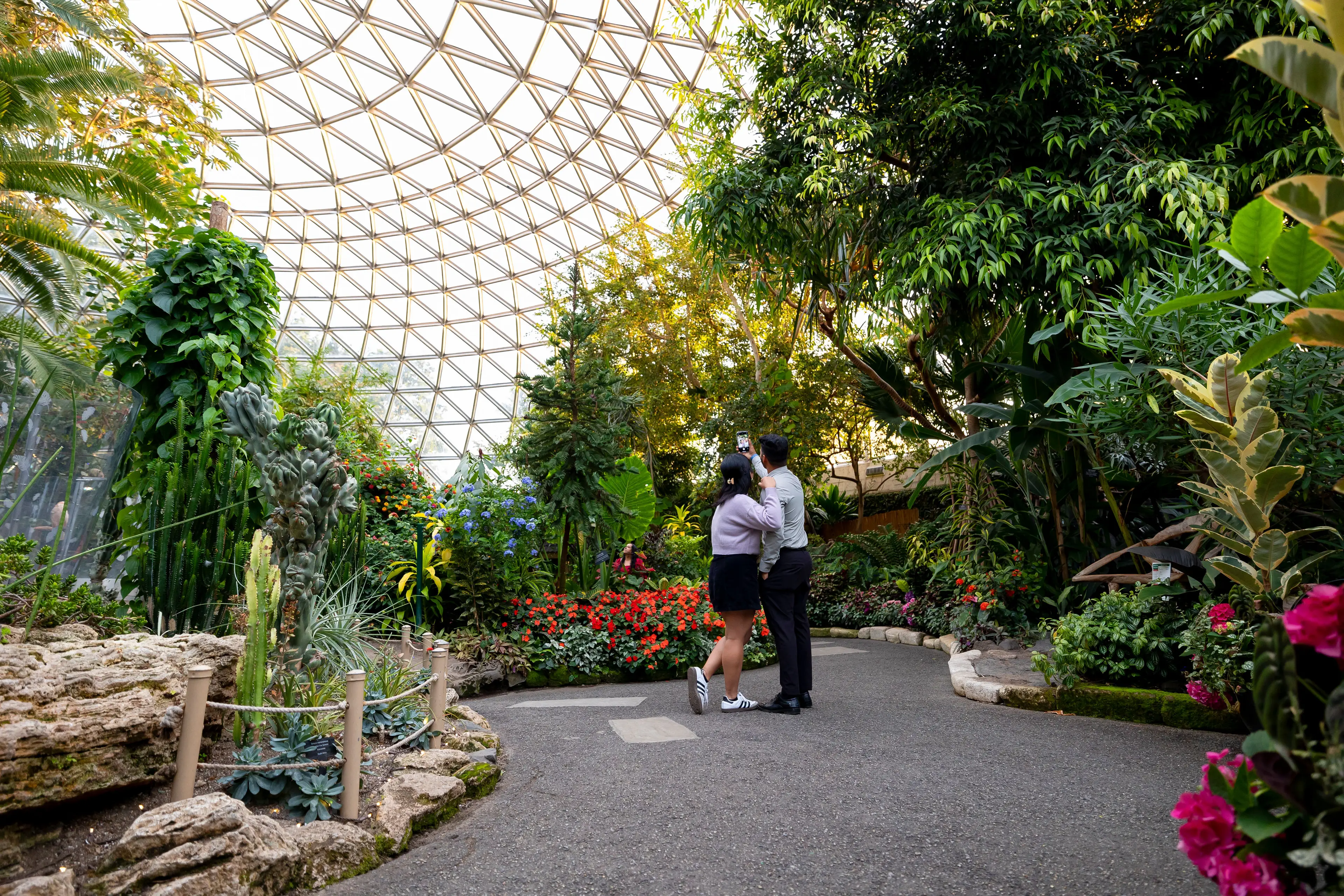 A couple posing for a selfie at the Bloedel Conservatory in Vancouver.