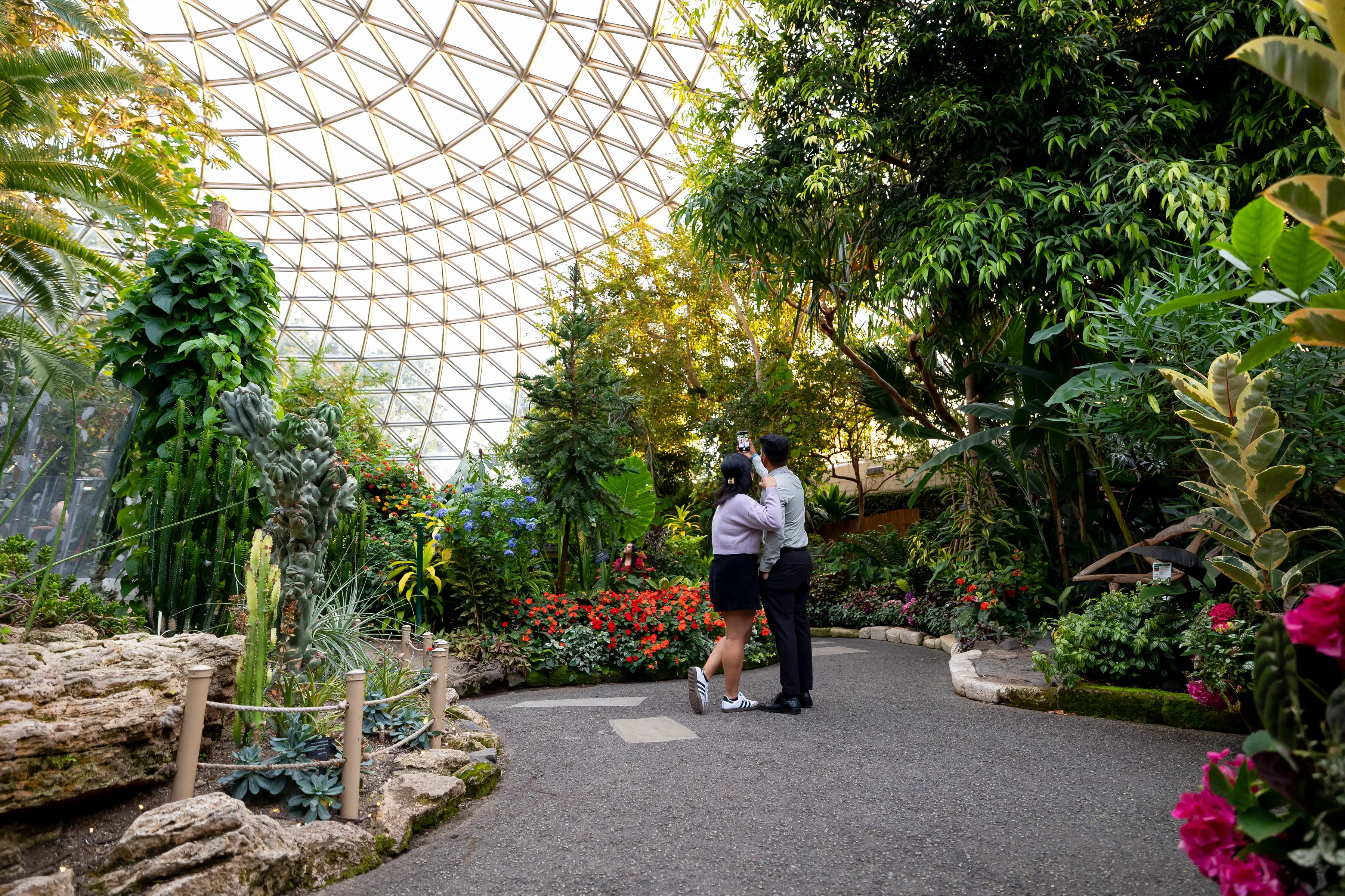 A couple posing for a selfie at the Bloedel Conservatory in Vancouver.