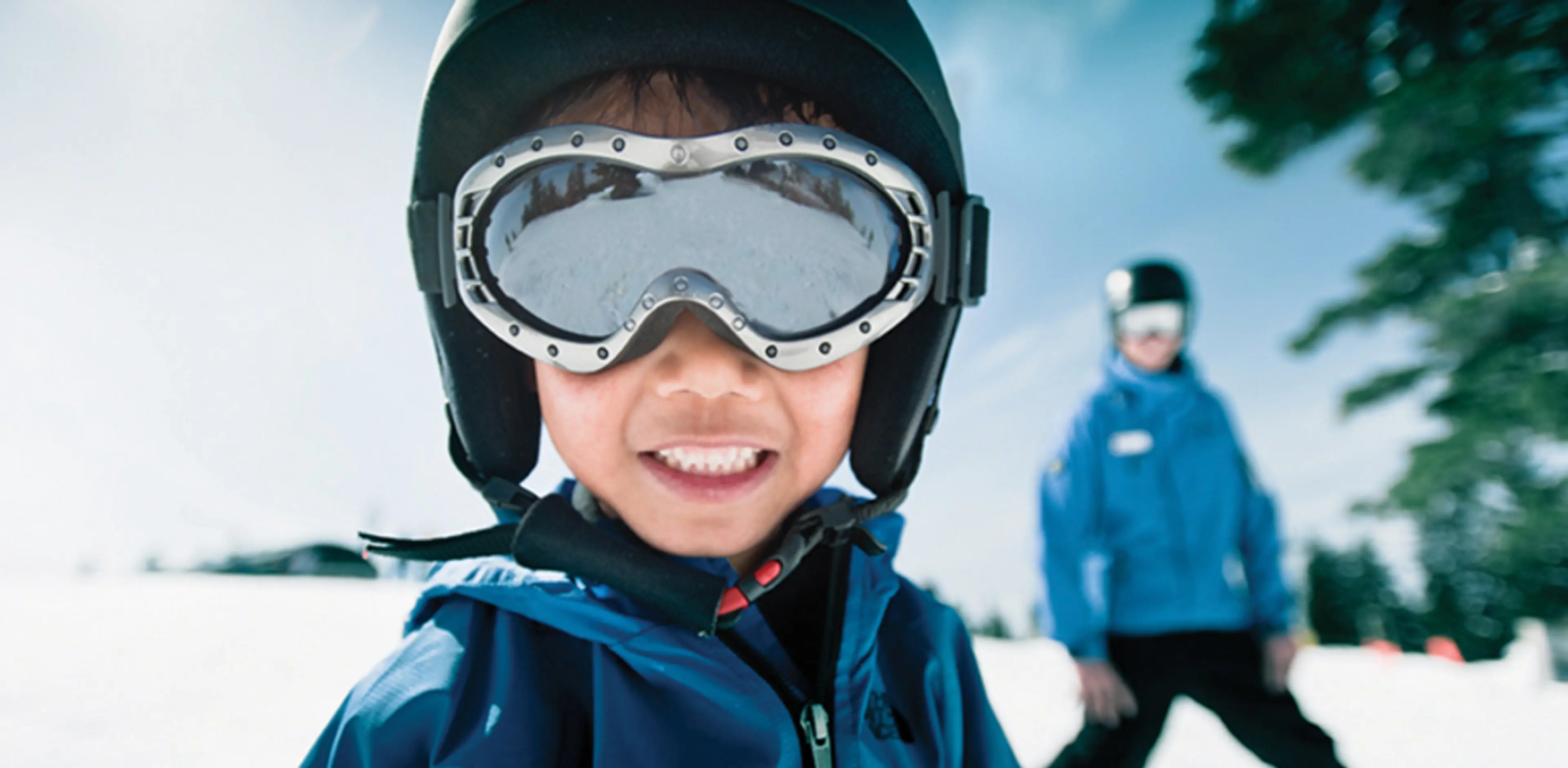 A close-up of a child enjoying a ski lesson at Grouse Mountain in Vancouver