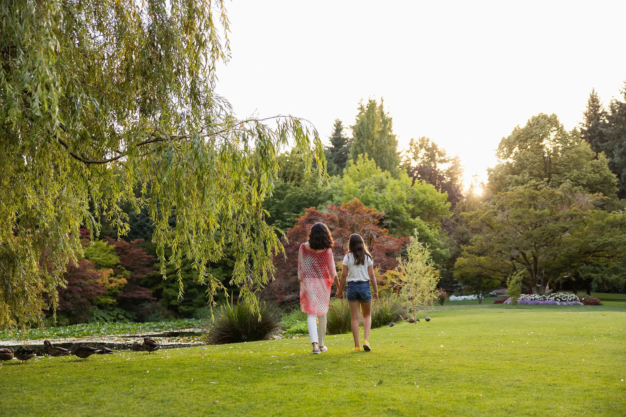 Two people walk in VanDusen Botanical Garden